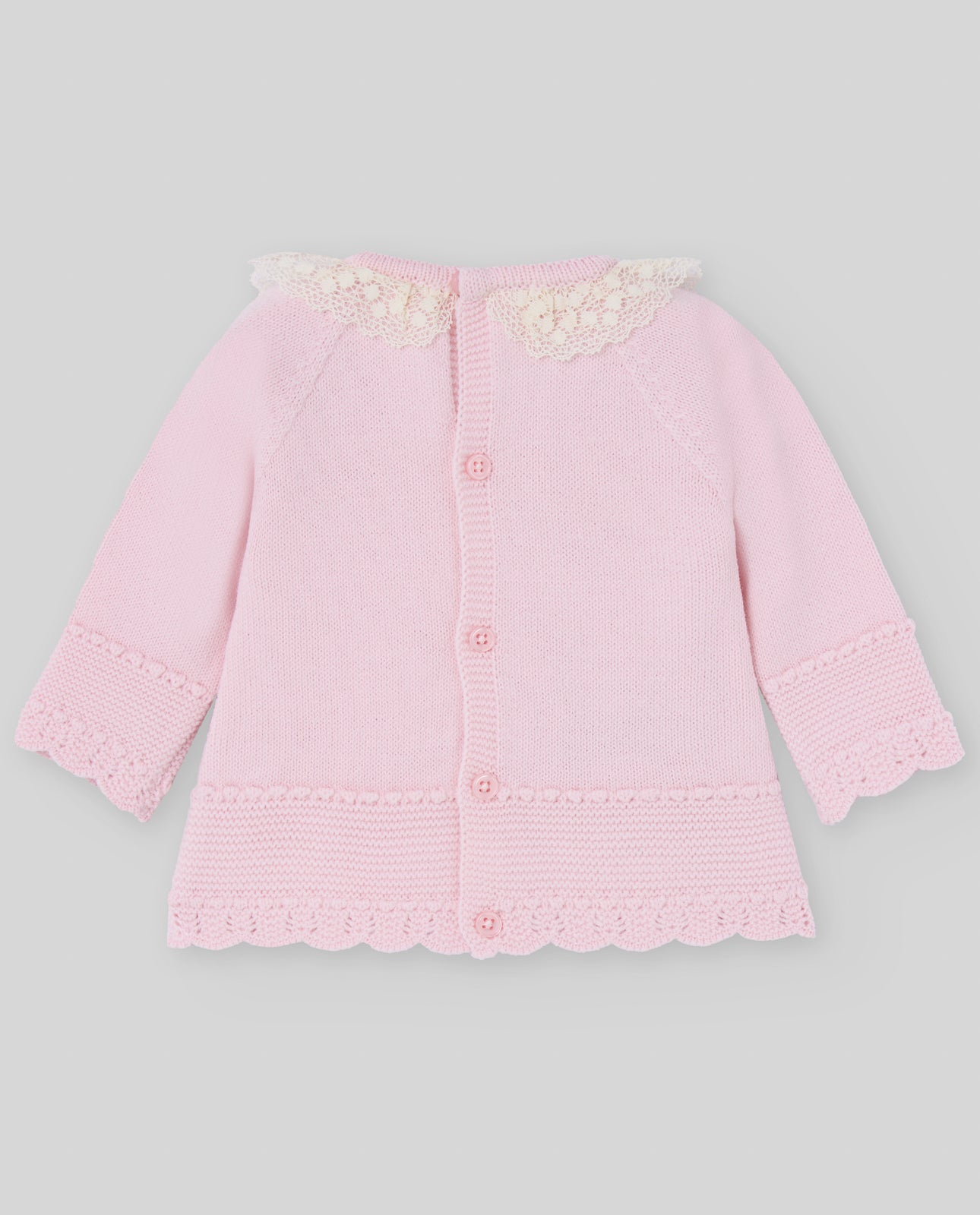 Pink baby cardigan with lace details on a gray background