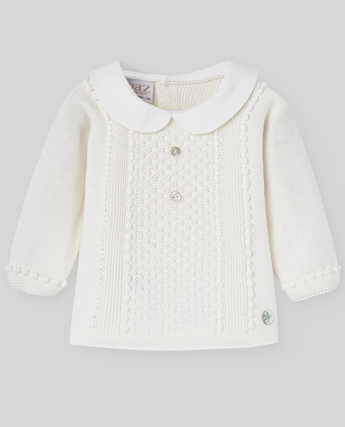White baby knitted jacket with a collar on a light gray background