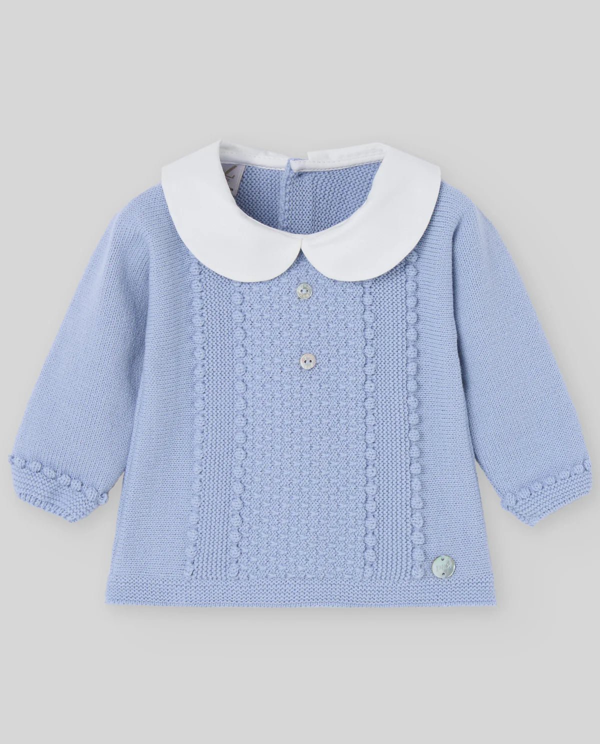 Blue knitted sweater with white collar on a gray background