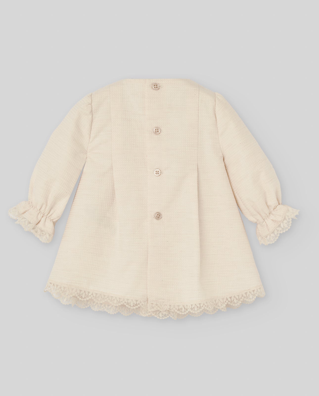 Beige baby coat with lace details on a light gray background