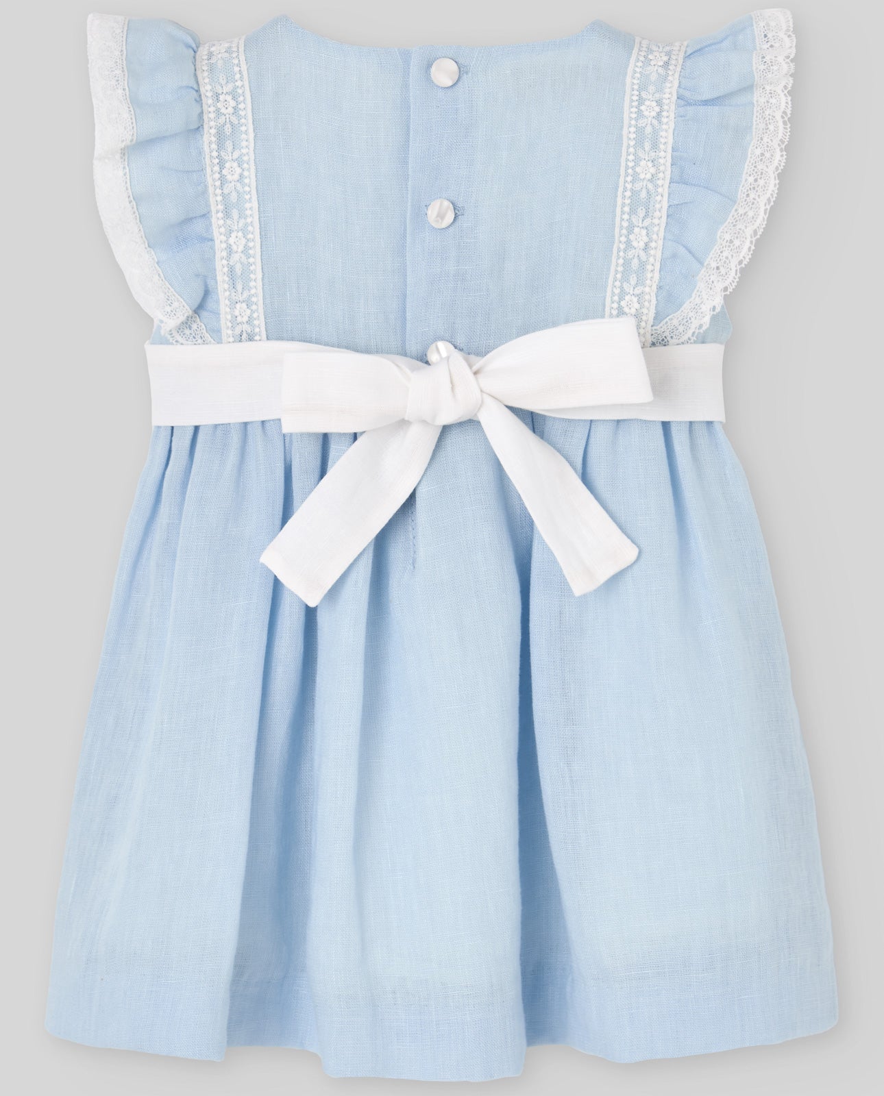 Light blue dress with white trim and a bow on a gray background