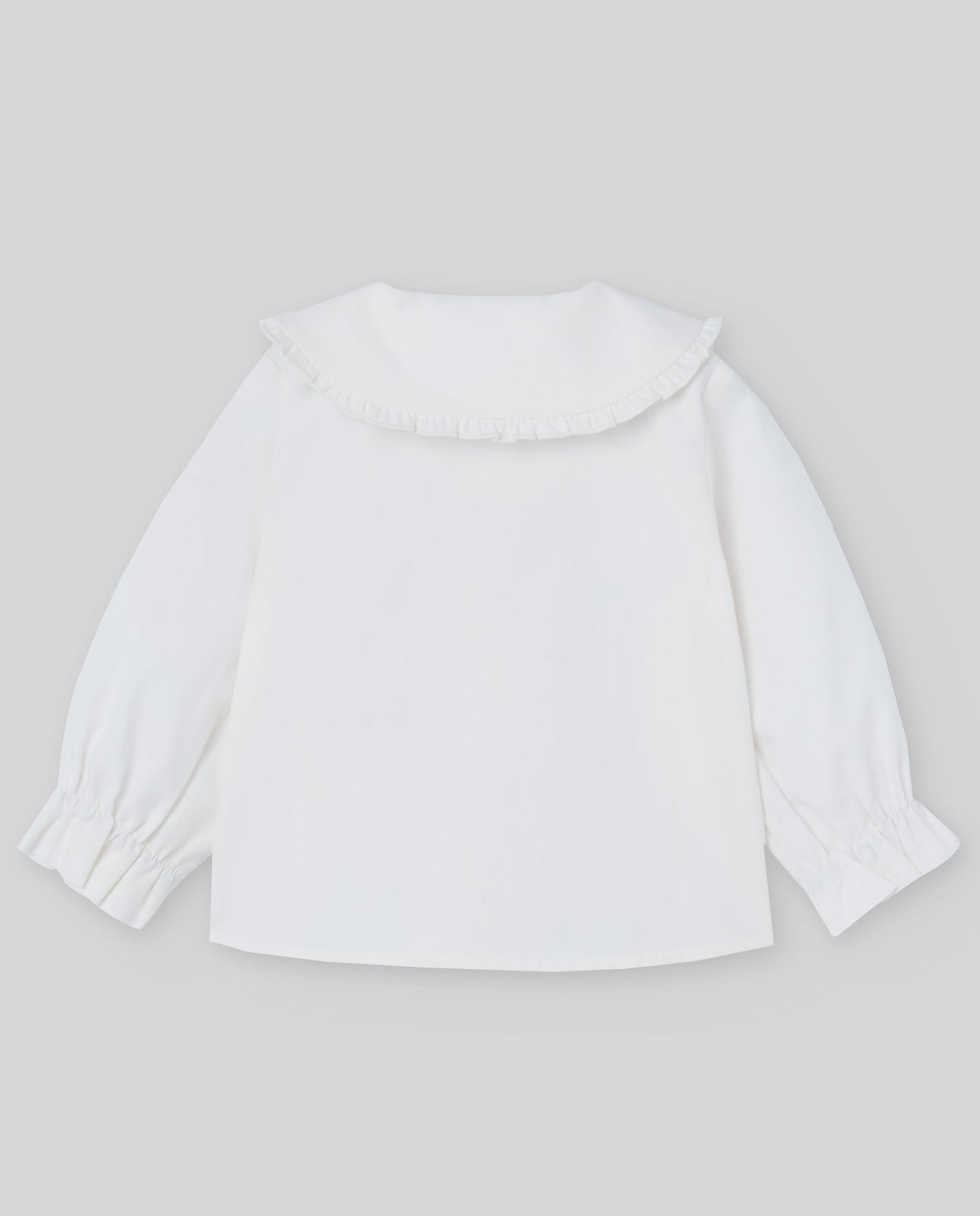 White blouse with a collar on a light gray background