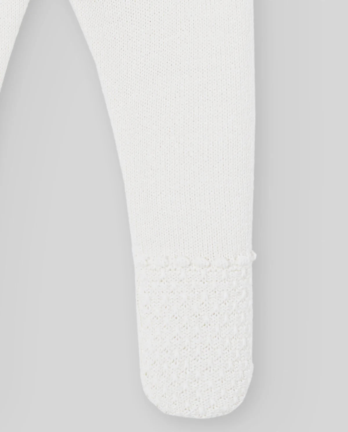 White sock with textured sole on a light gray background