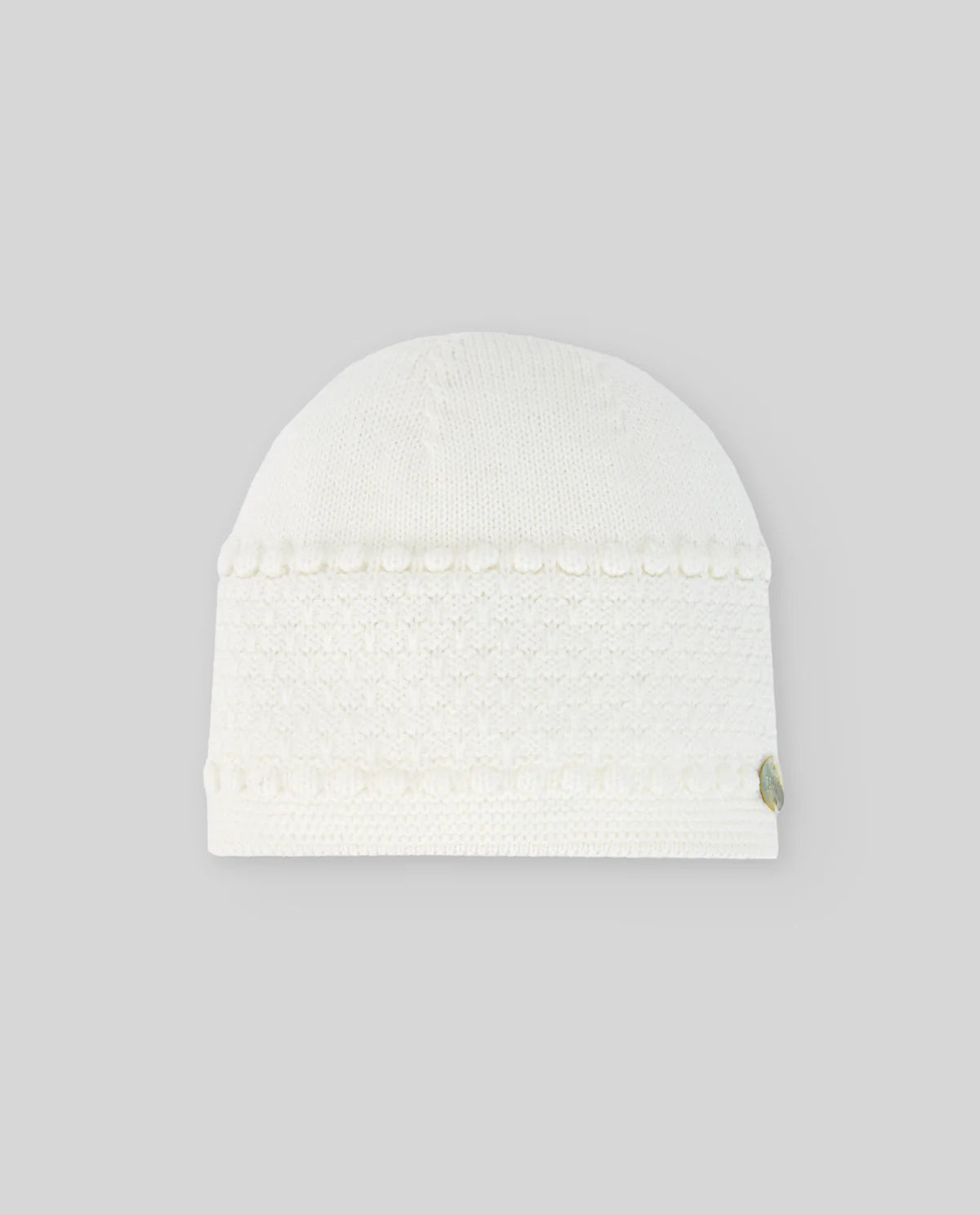 White knit beanie on a light gray background