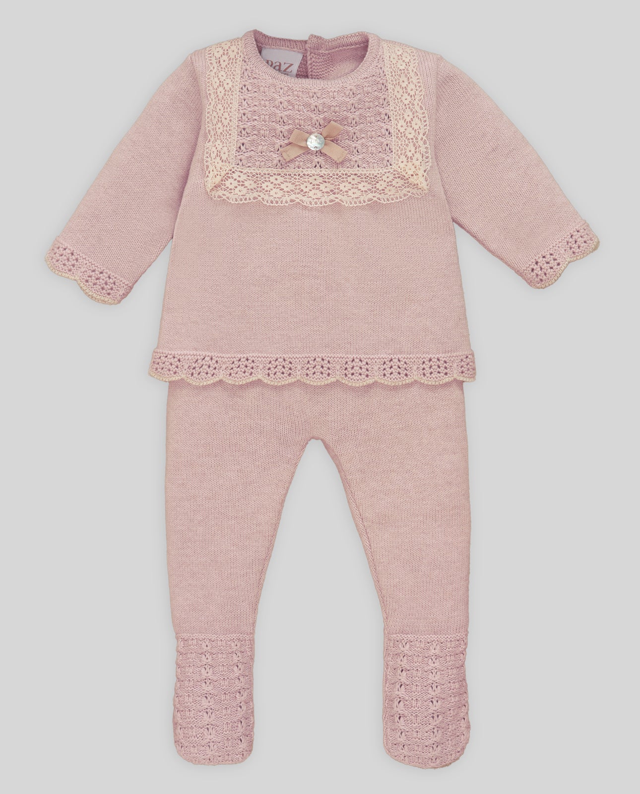 Pink baby outfit with lace details on a white background