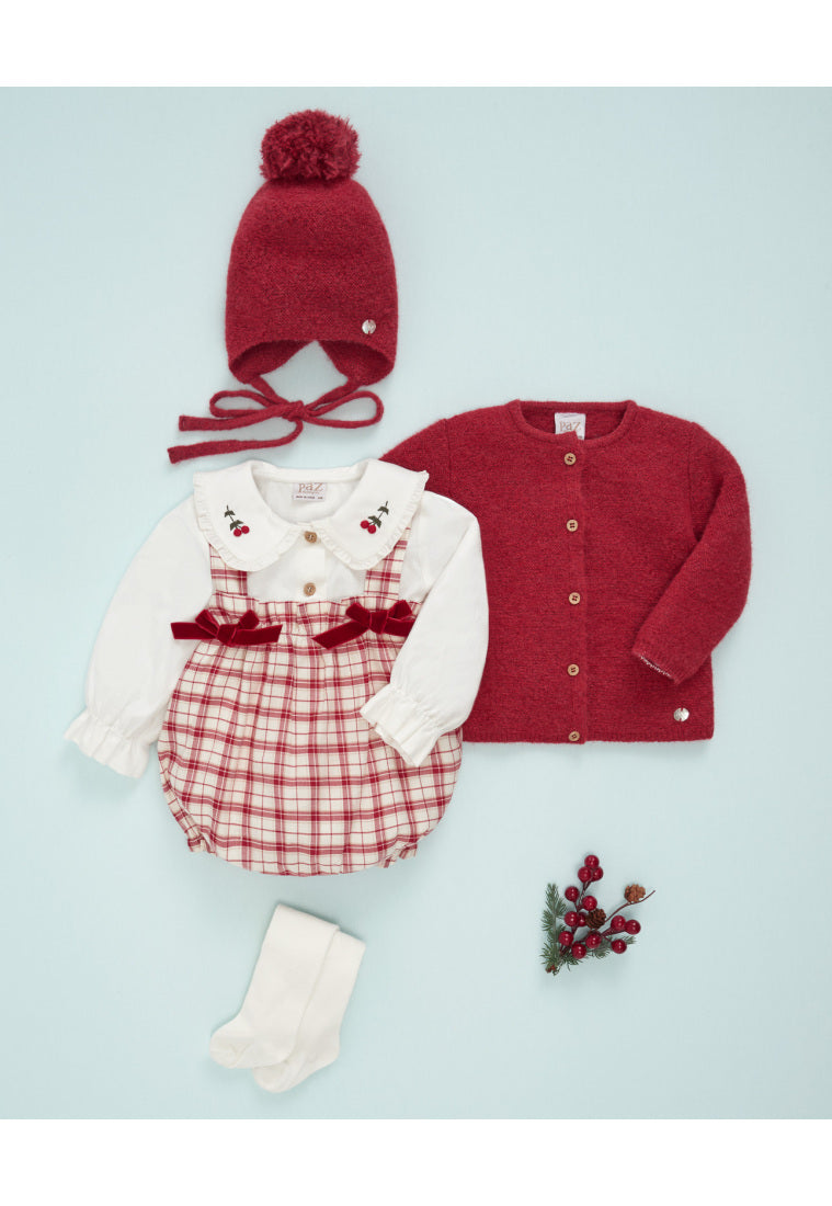 Baby outfit set with red and white items on a light blue background