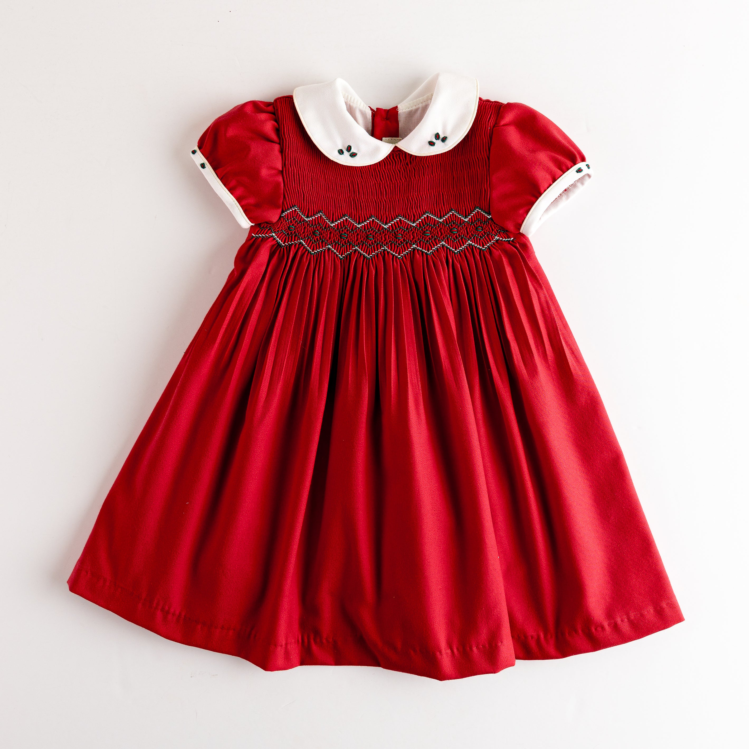 Red dress with white collar on a light gray background