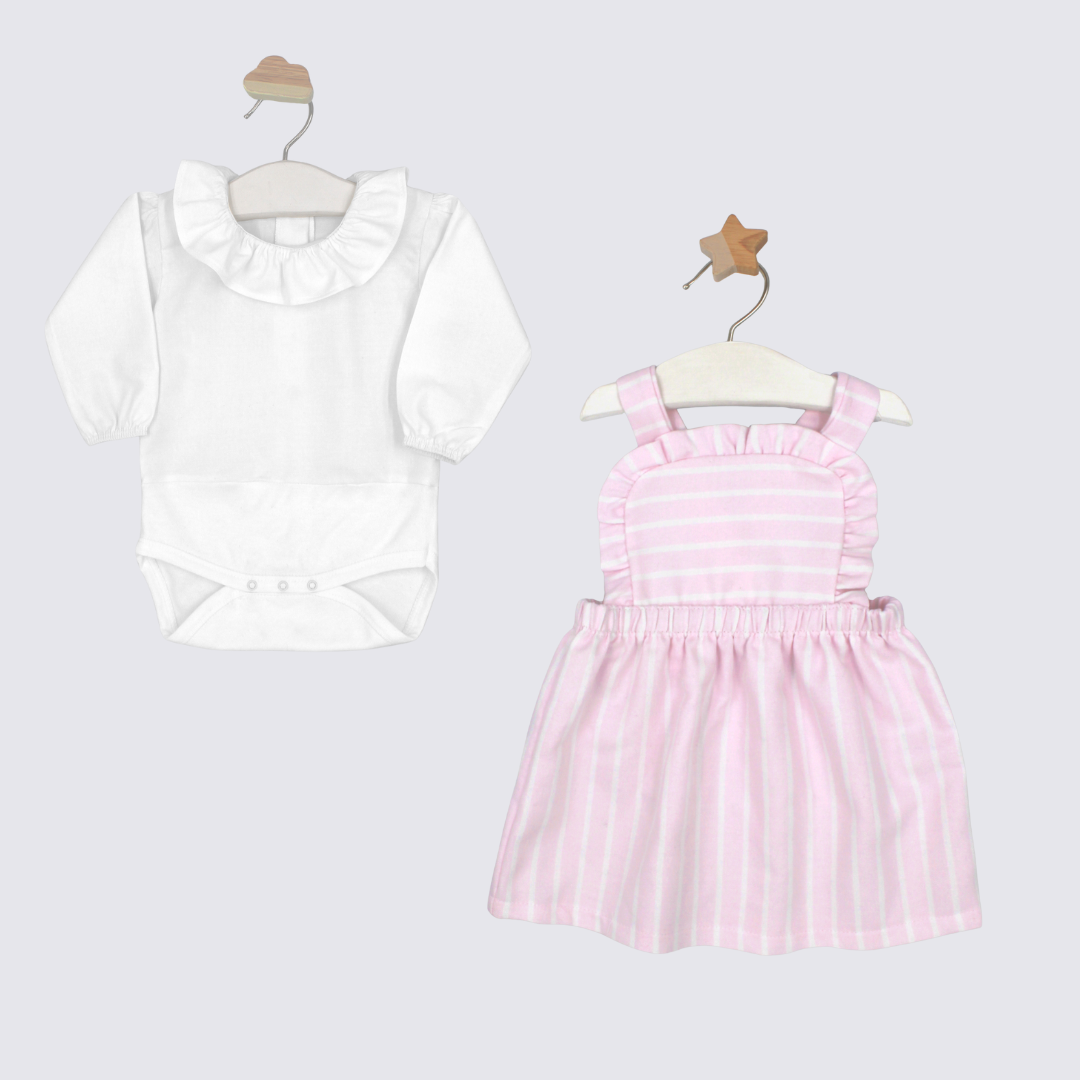 White blouse with ruffled collar and pink striped dress on hangers against a light gray background