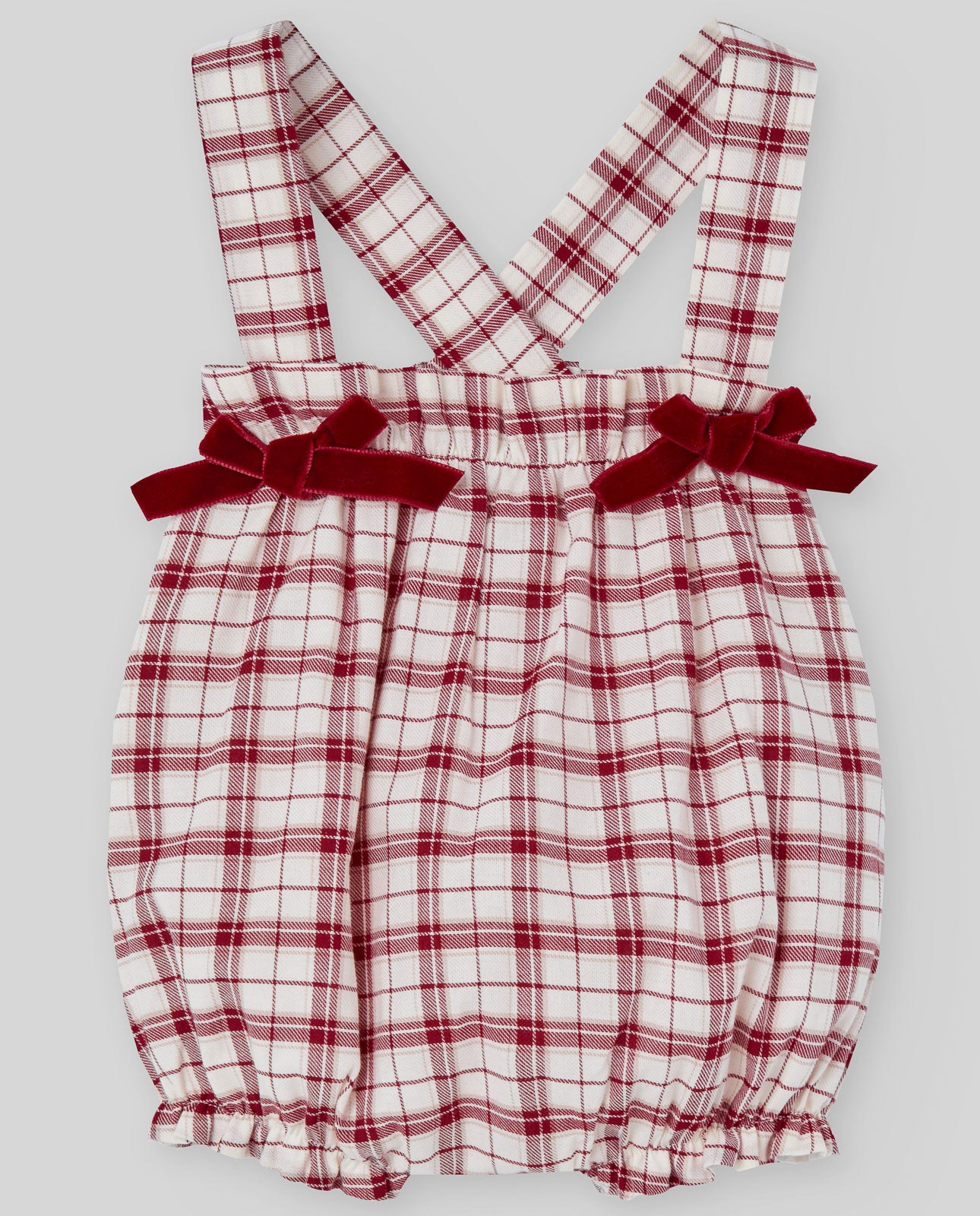 Red and white plaid romper with bow straps on a gray background