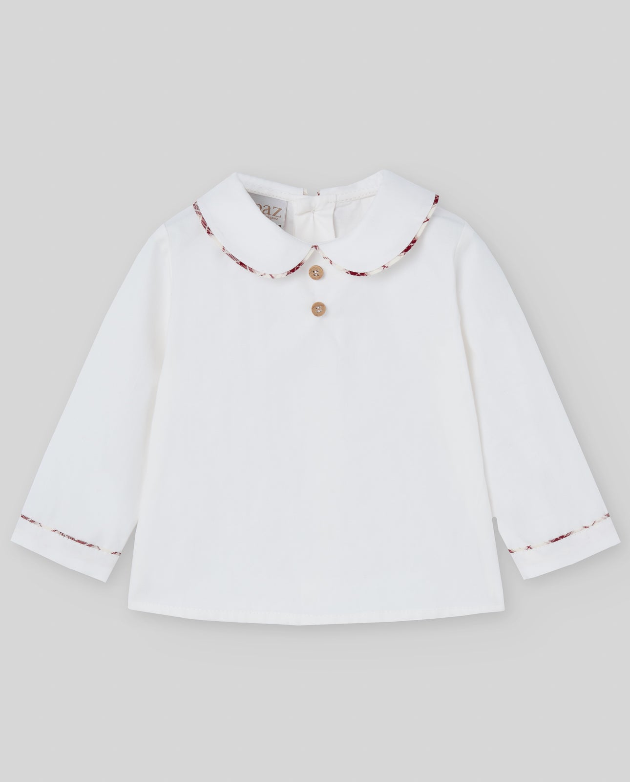 White blouse with a patterned collar on a light gray background