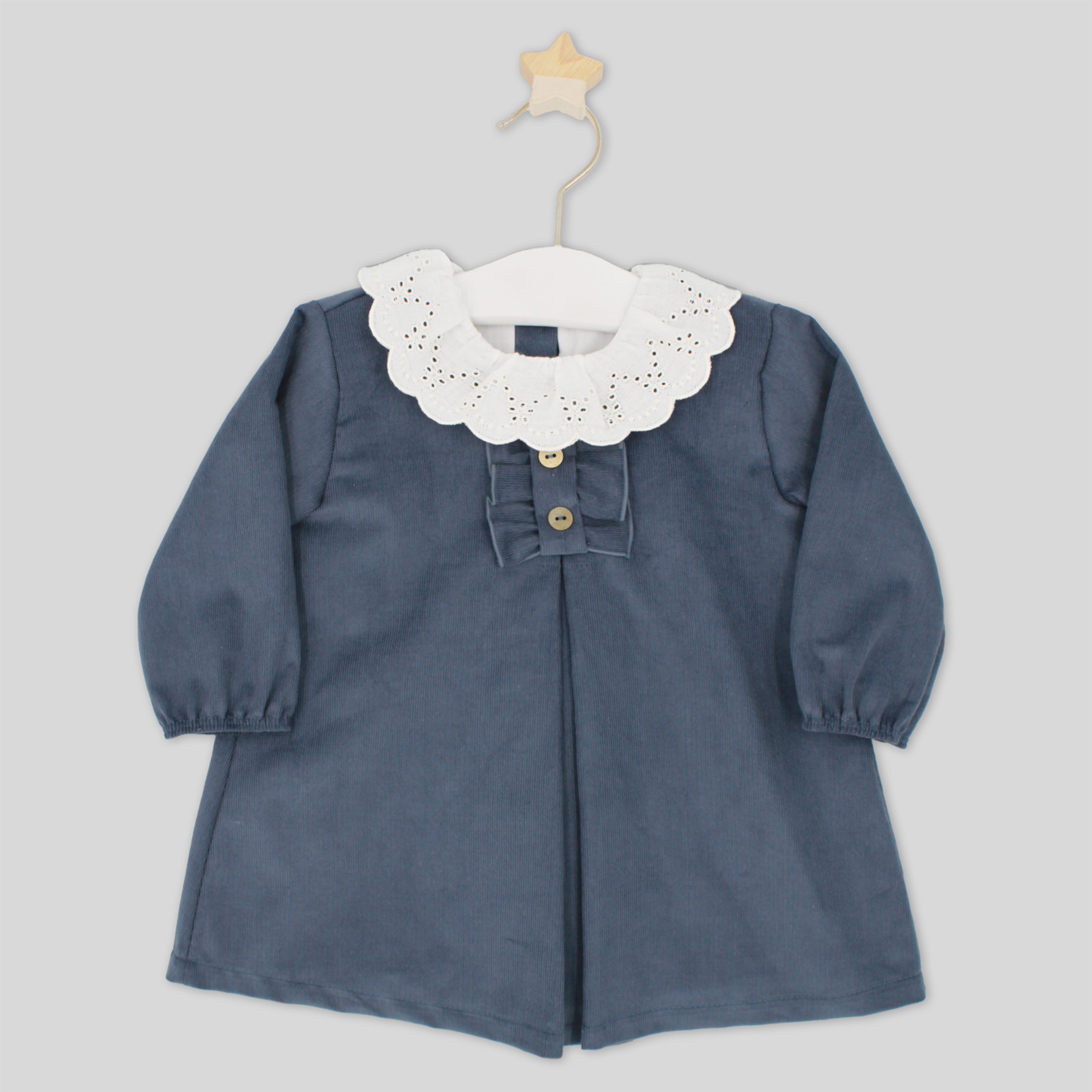 Blue dress with white lace collar on a hanger against a light gray background