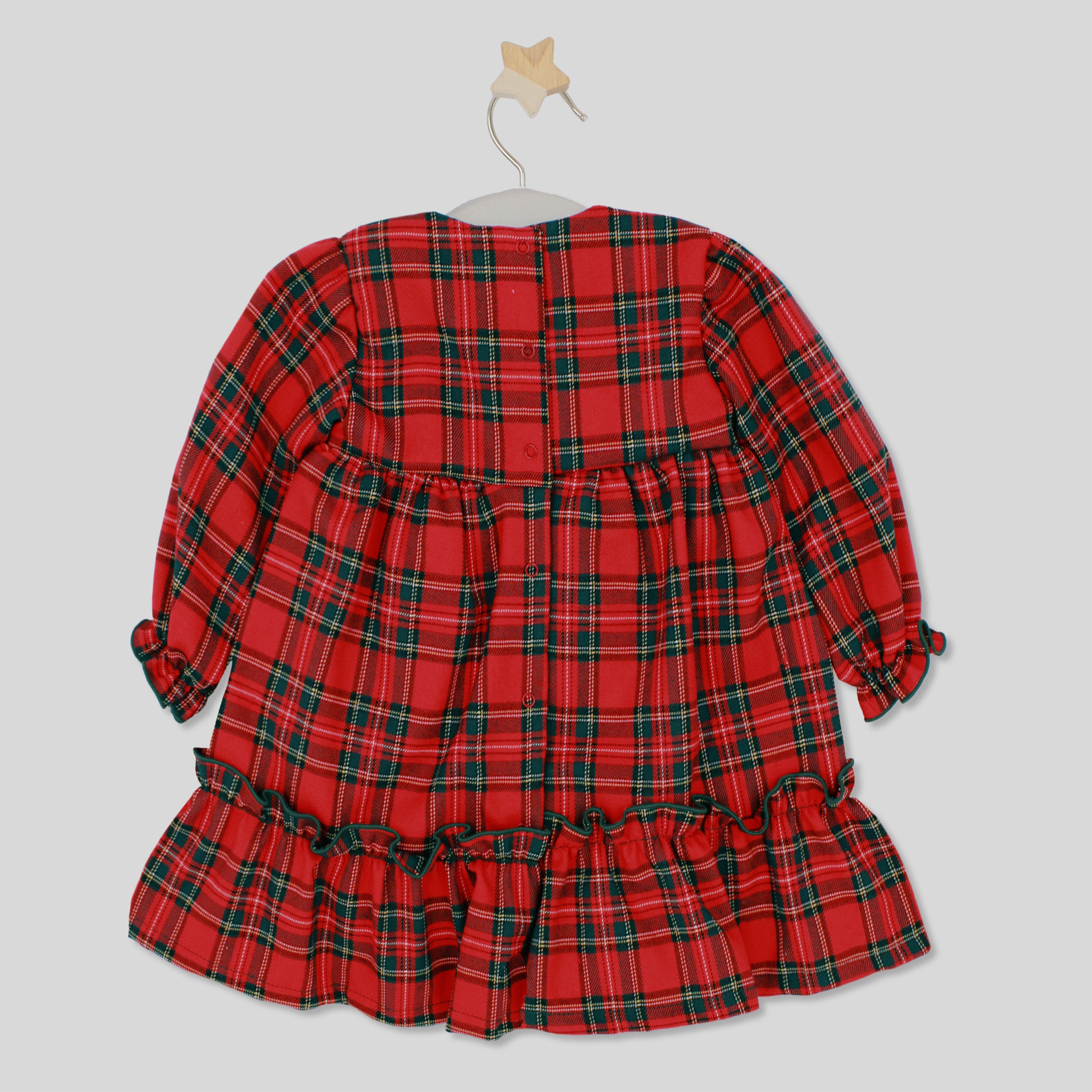 Red plaid dress on a hanger against a light gray background