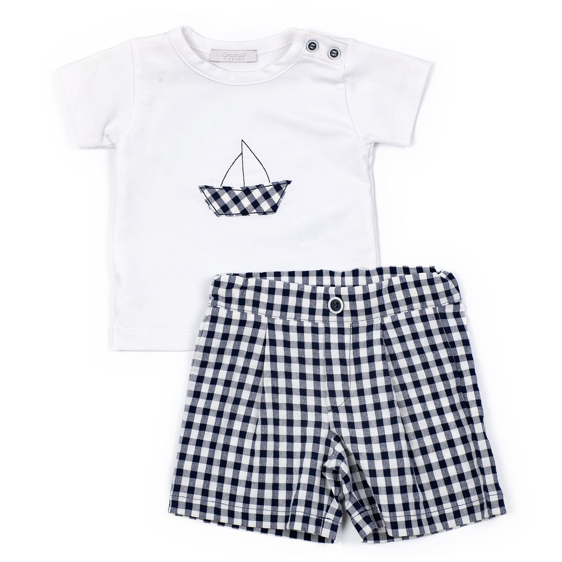White t-shirt with a boat design and black and white checkered shorts on a white background