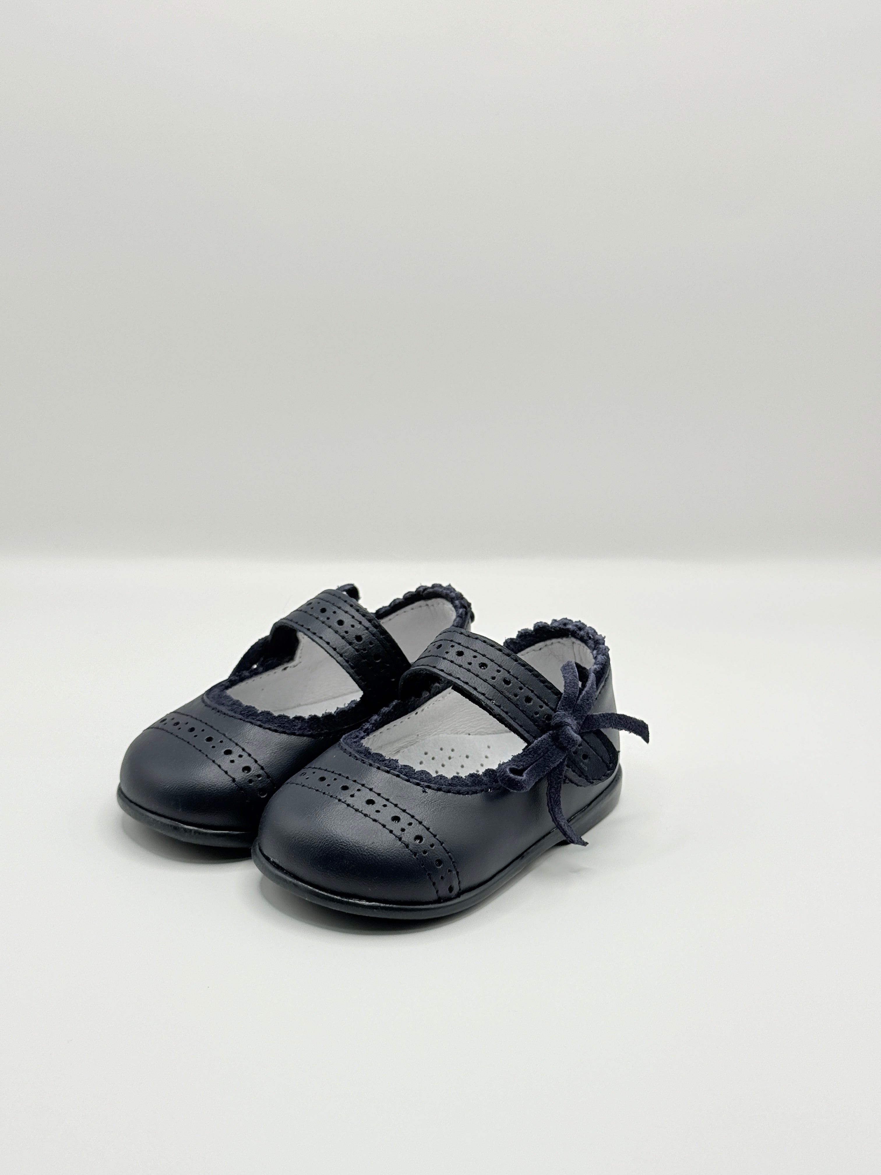 Pair of black leather shoes on a white background