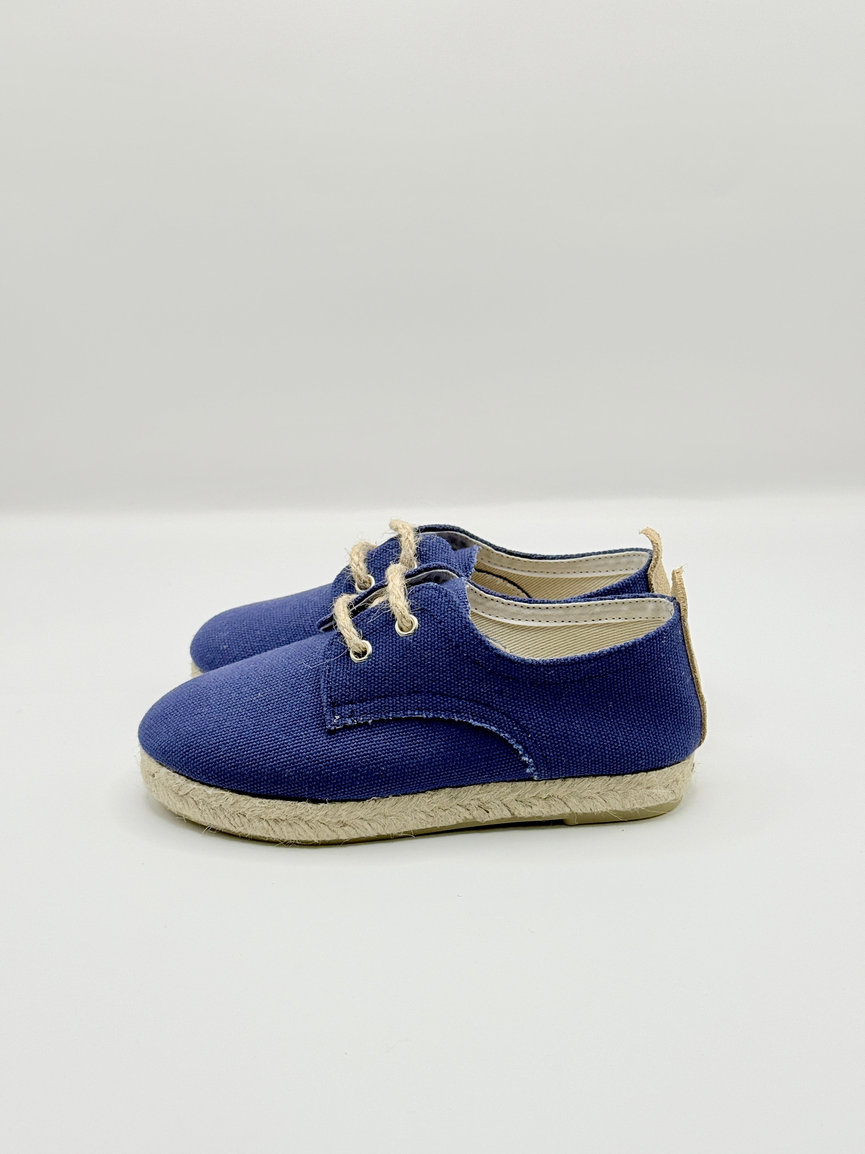 Pair of blue espadrilles on a white background