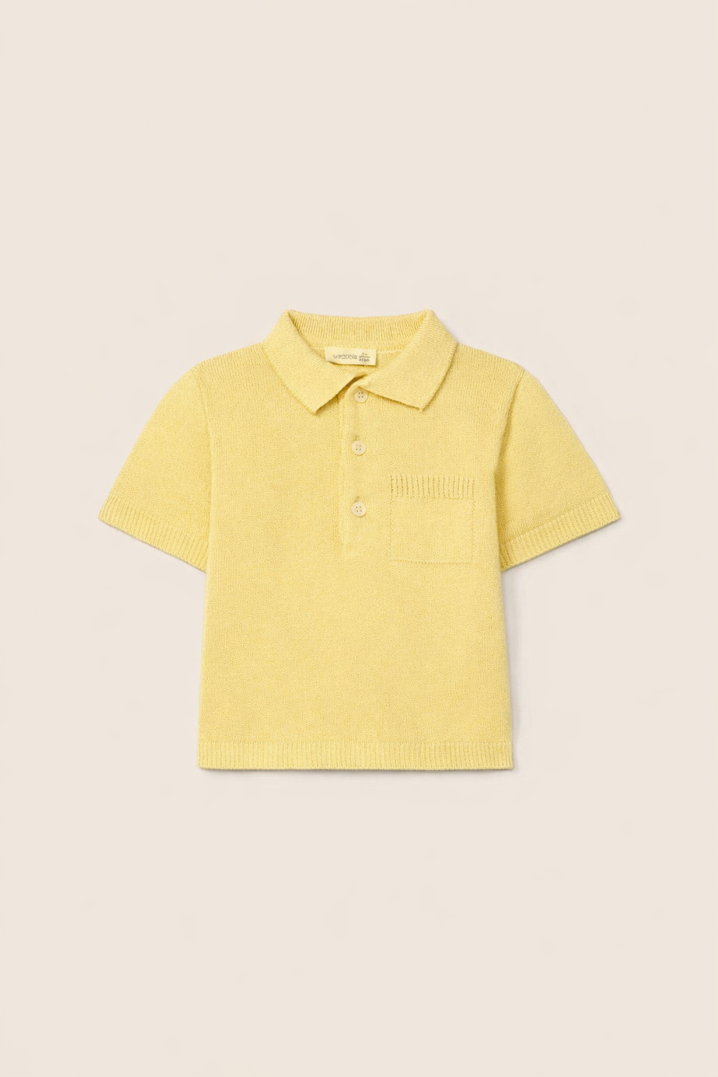 Yellow polo shirt on a beige background