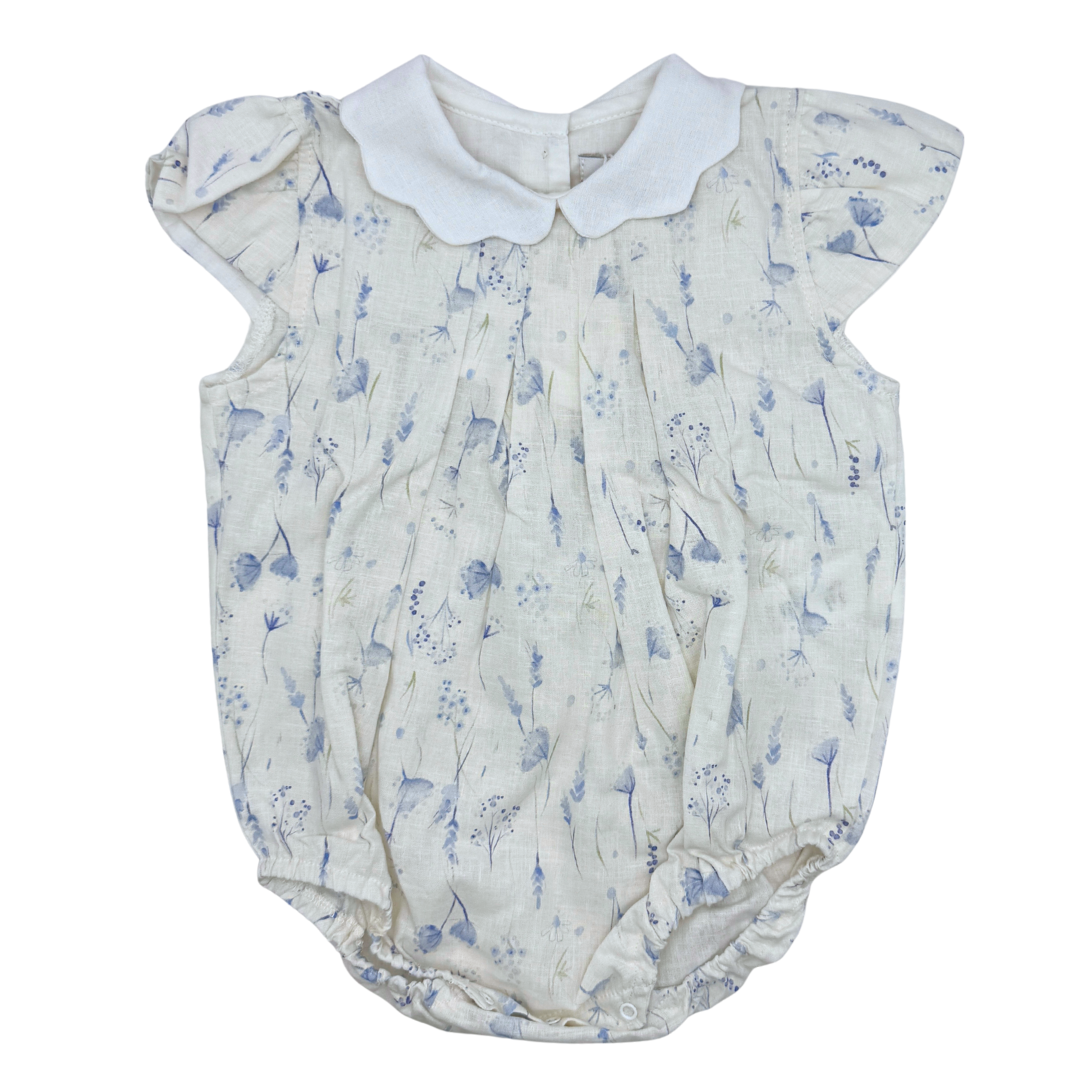 Baby romper with floral pattern and white collar on a white background
