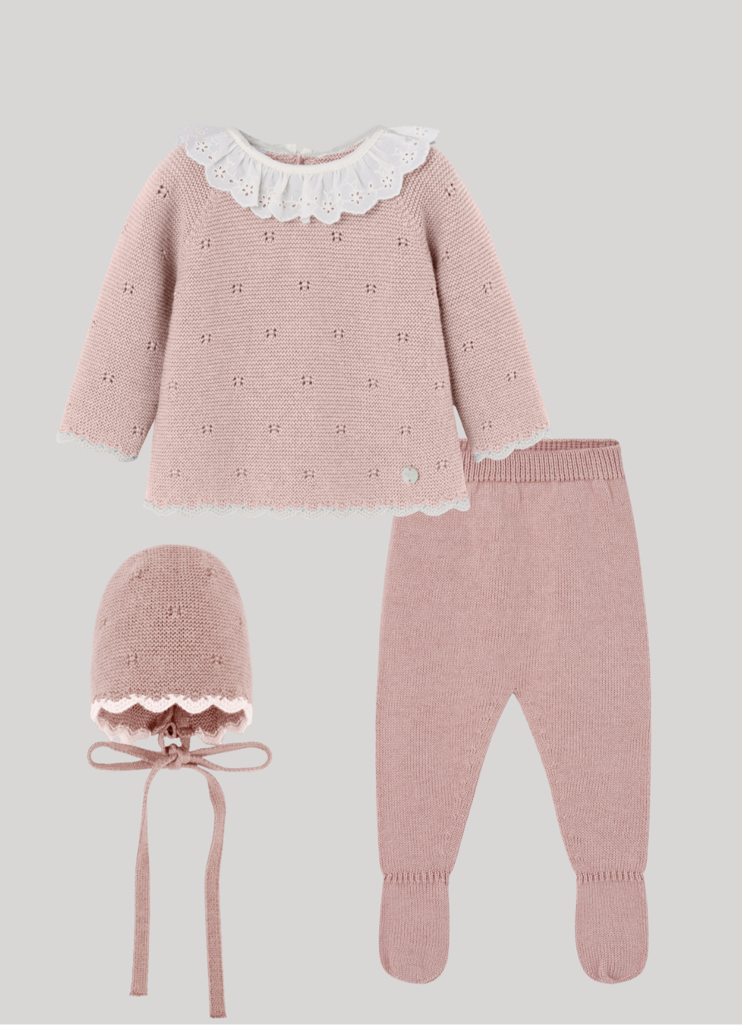 Pink baby outfit set with top, pants, and bonnet on a light gray background