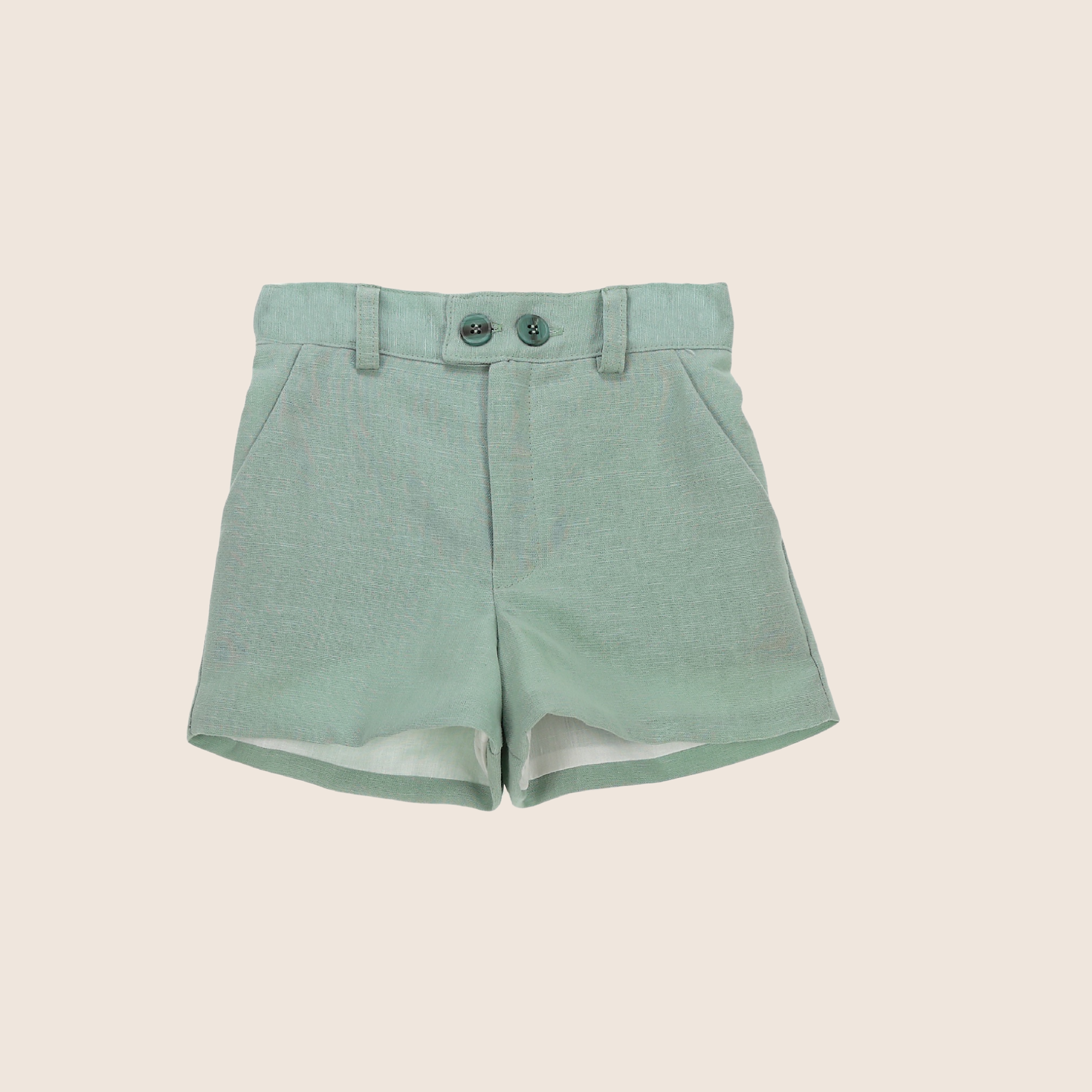 Green shorts on a beige background