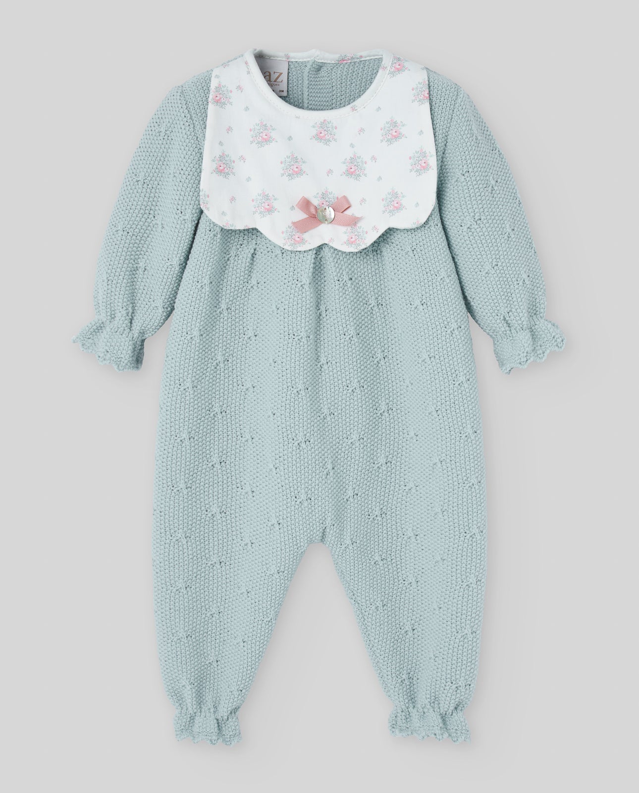 Light blue baby romper with floral bib on a light gray background