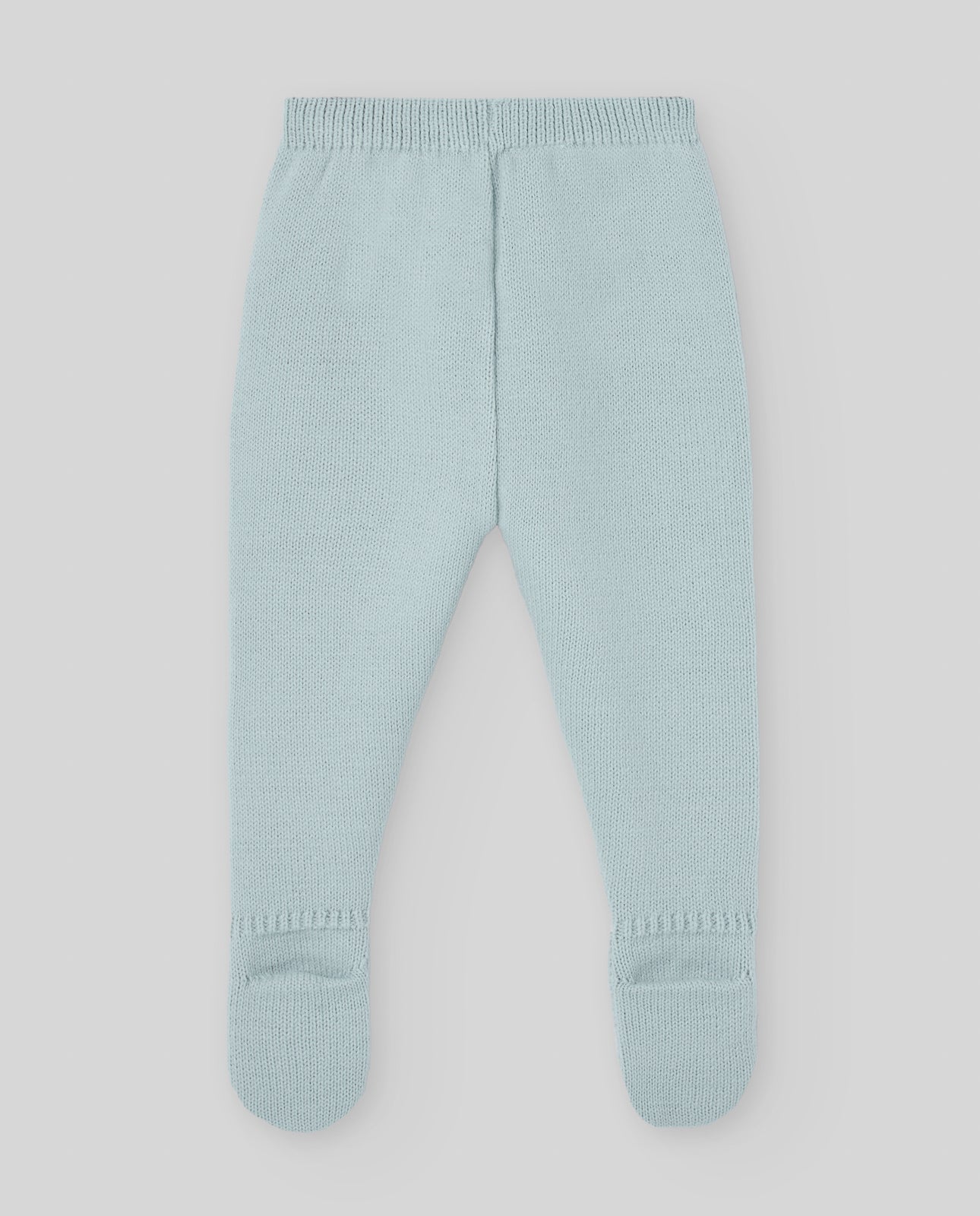 Light green baby pants on a light gray background
