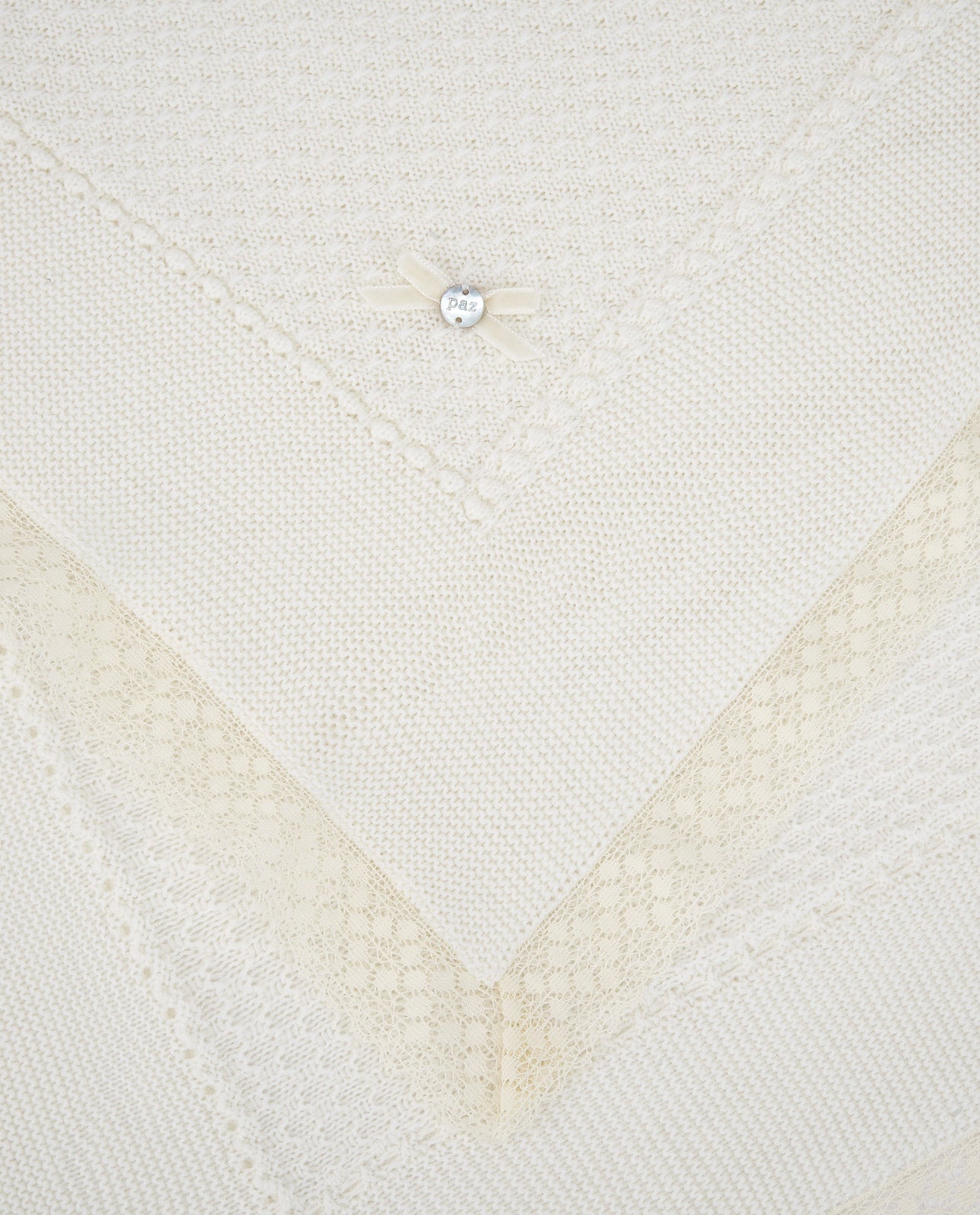 Close-up of a textured white fabric with a diamond pattern