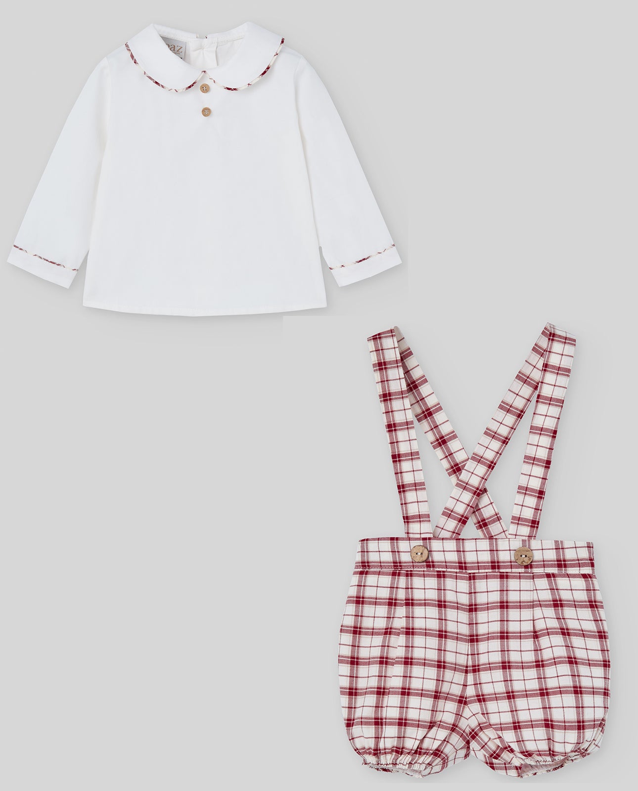 White shirt with red trim and plaid shorts with suspenders on a light gray background