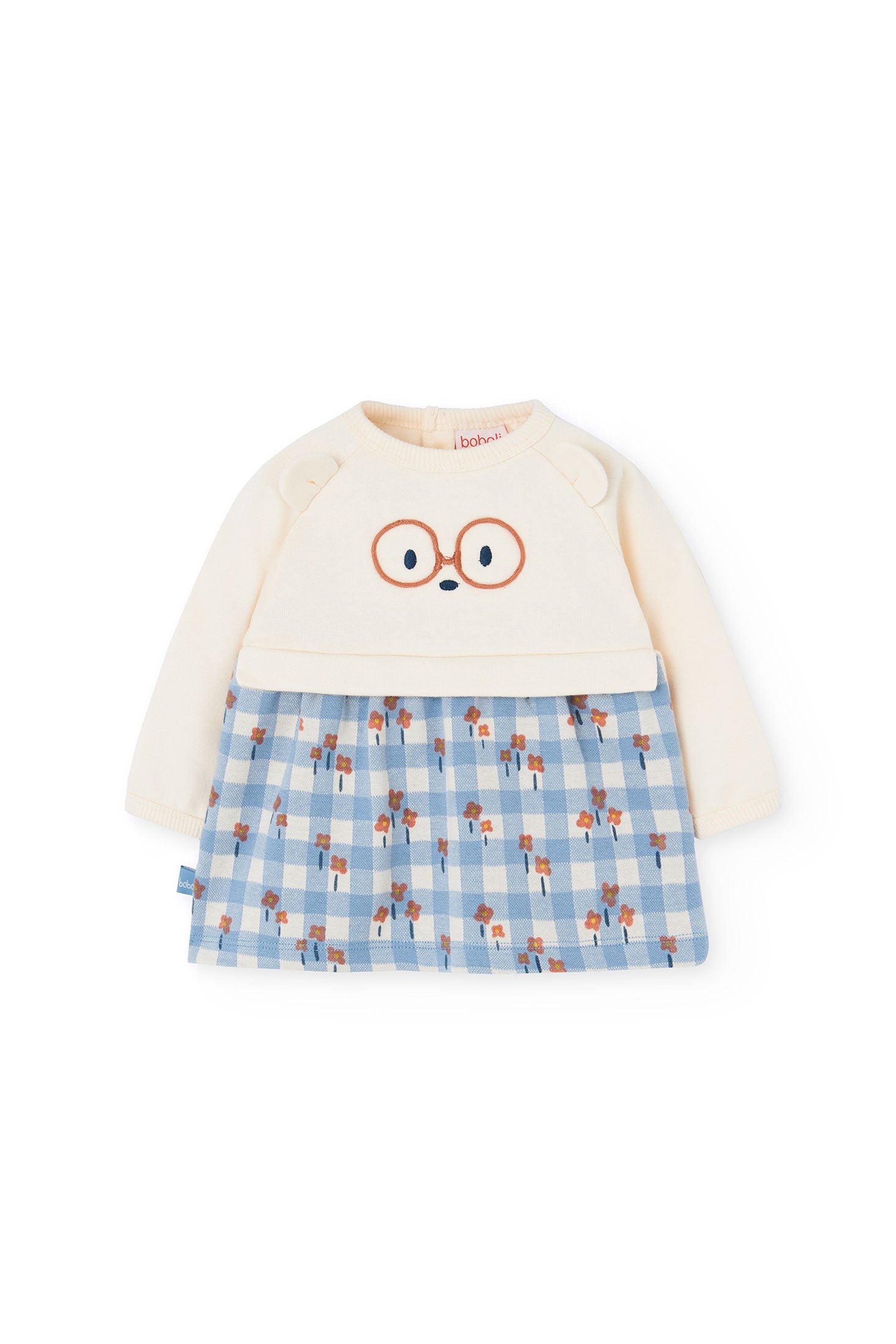 Children's outfit with cream top and blue checkered skirt on a white background