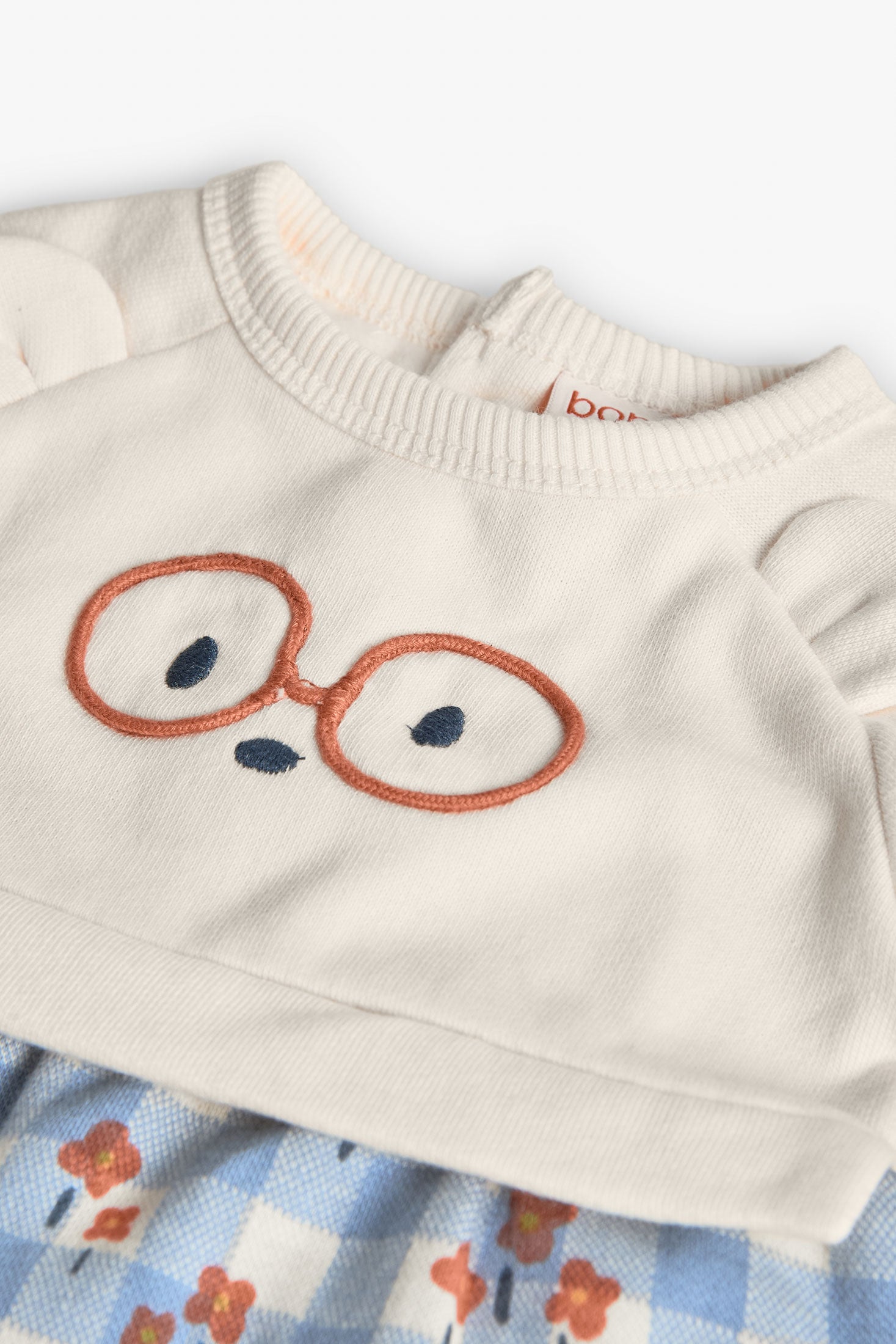 Children's sweater with embroidered glasses design on a white background
