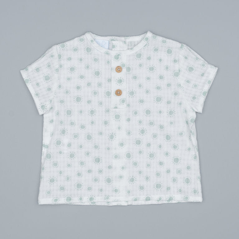 White t-shirt with subtle pattern on an ivory and mint background