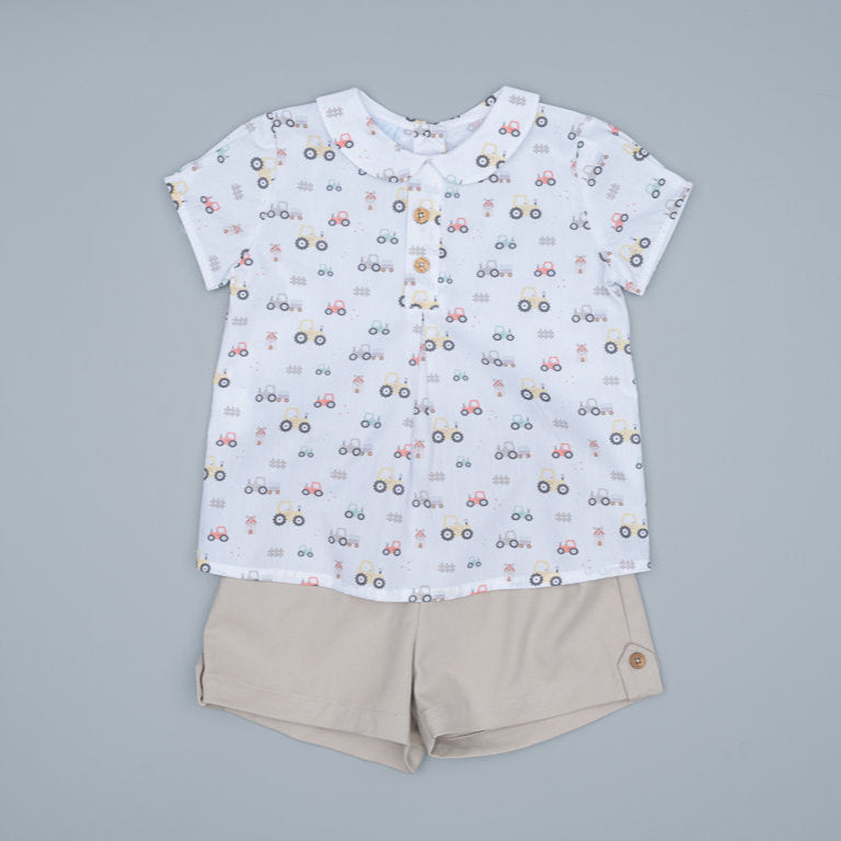 Children's shirt with car pattern and beige shorts on a gray background
