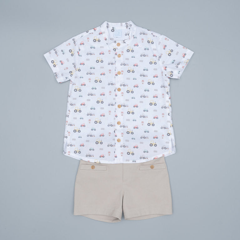 White shirt with colorful pattern and beige shorts on a white background