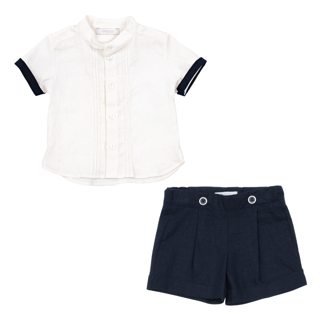 White shirt with black sleeves and navy shorts on a white background