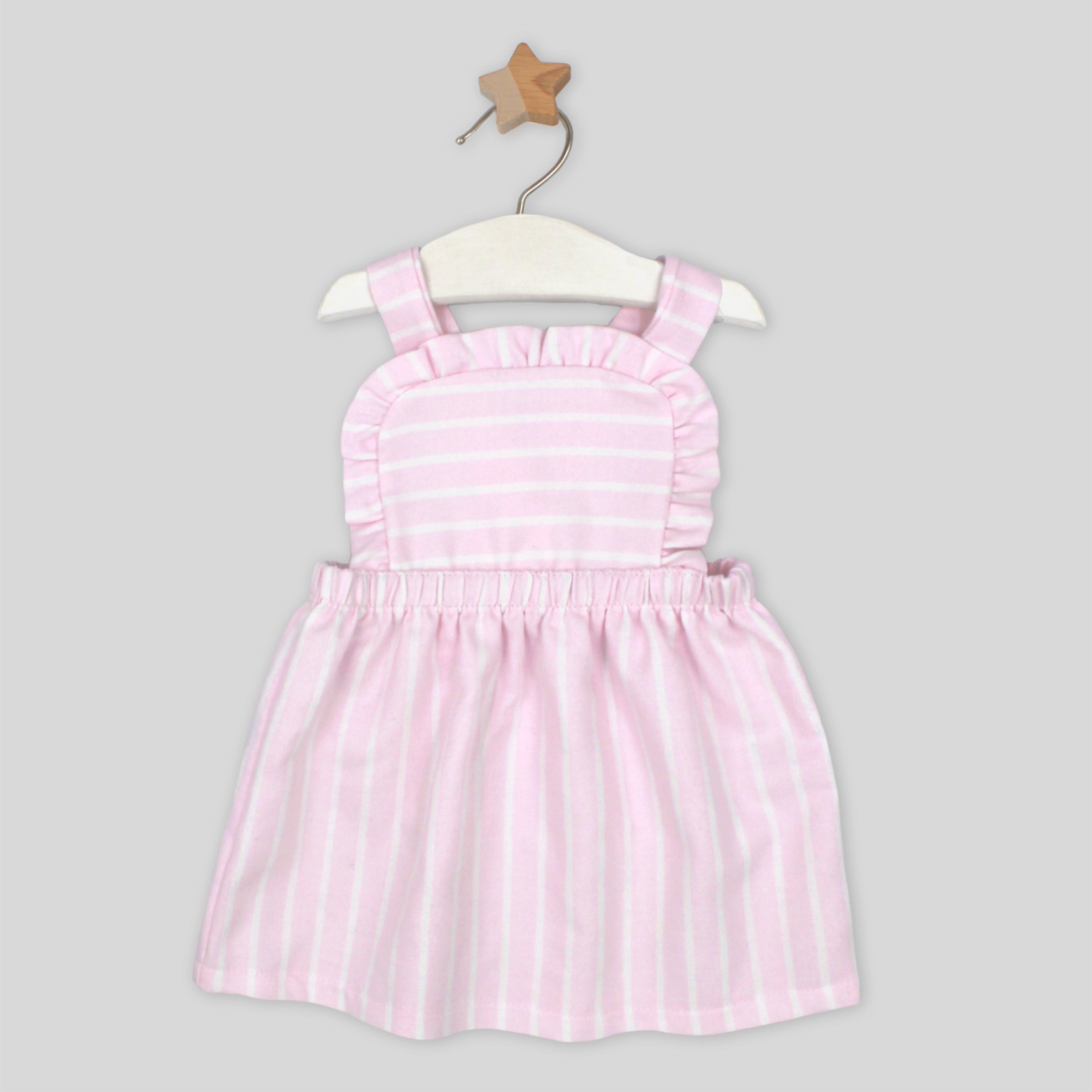 Pink and white striped dress on a hanger against a gray background
