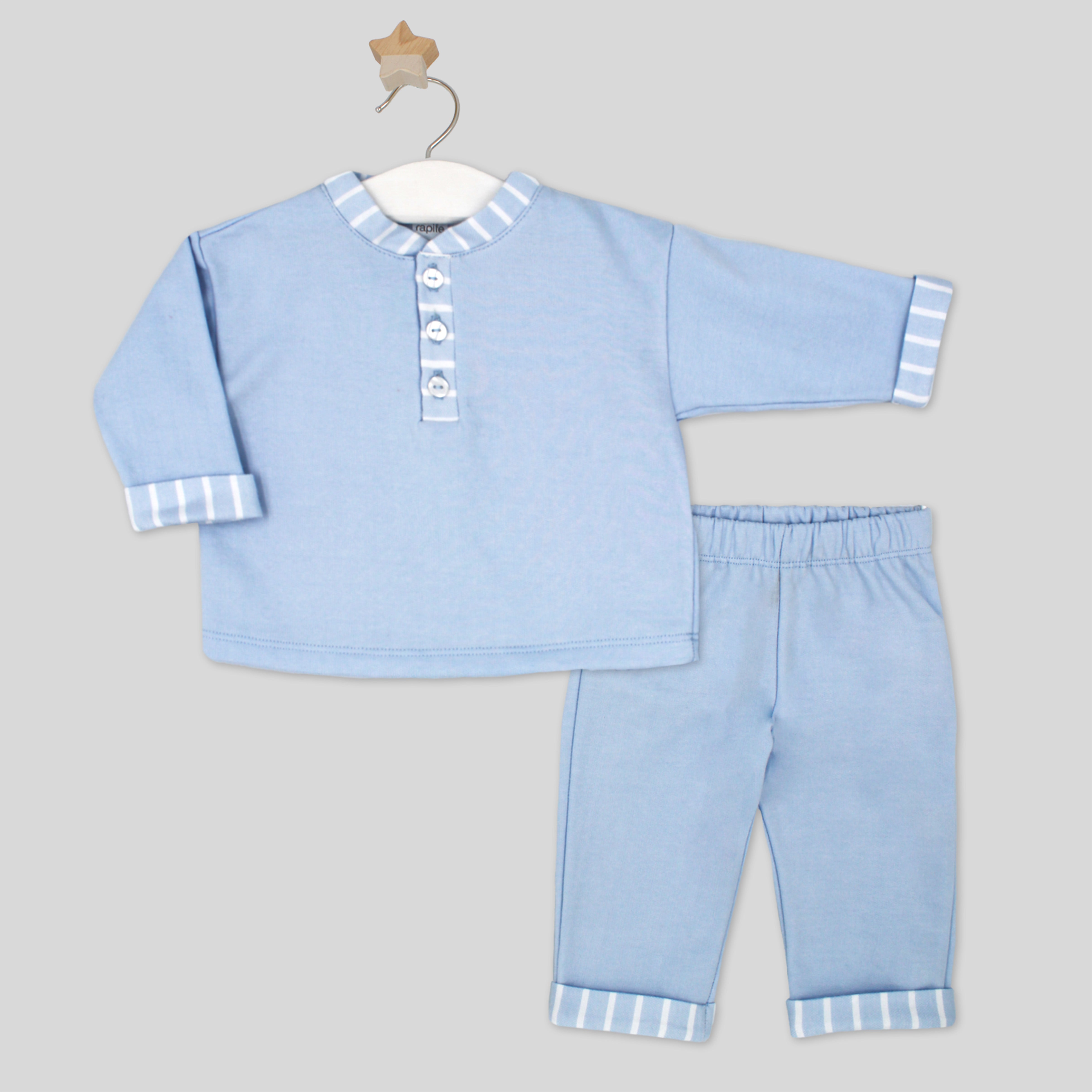 Light blue children's outfit with striped details on a gray background