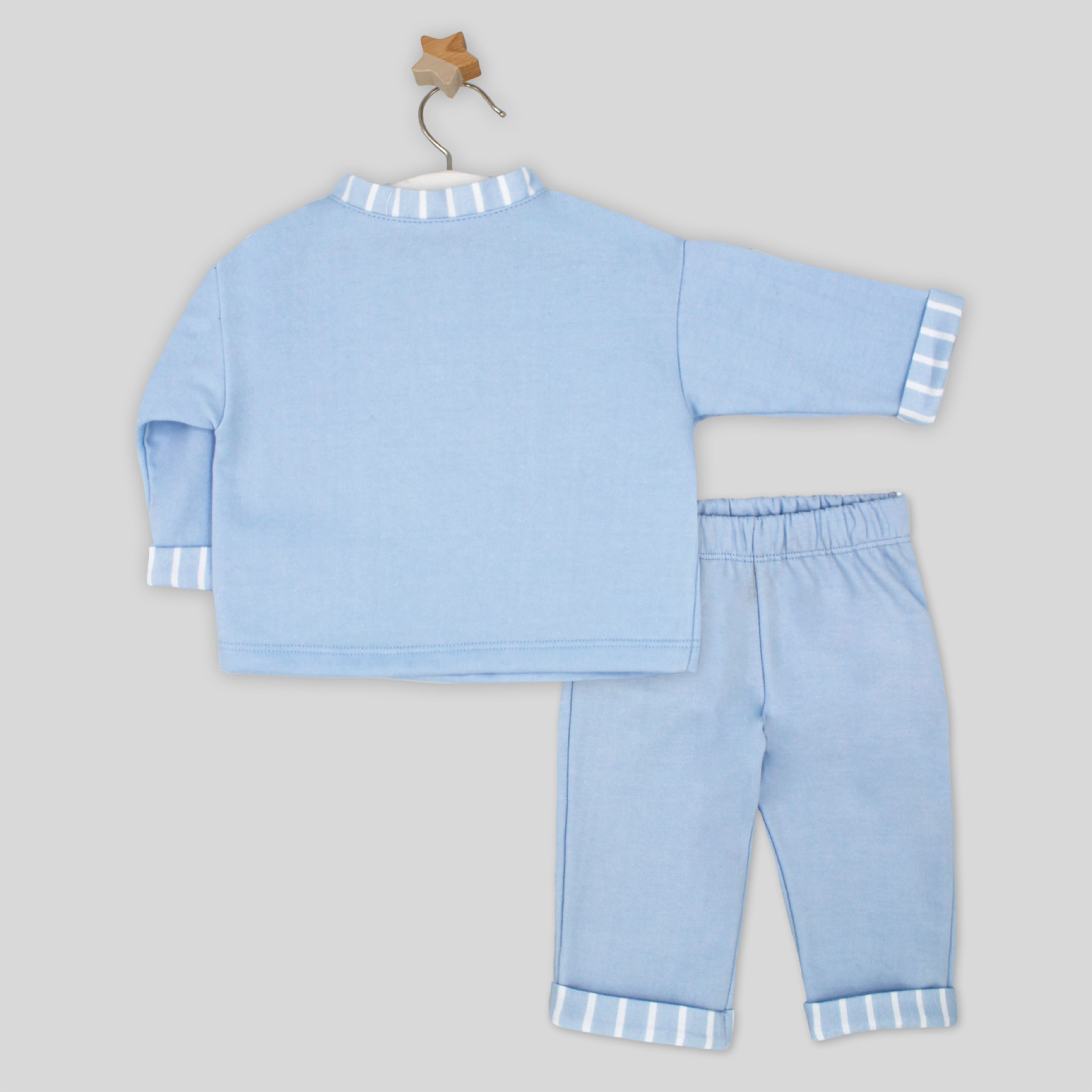 Light blue children's pajama set with striped cuffs on a gray background