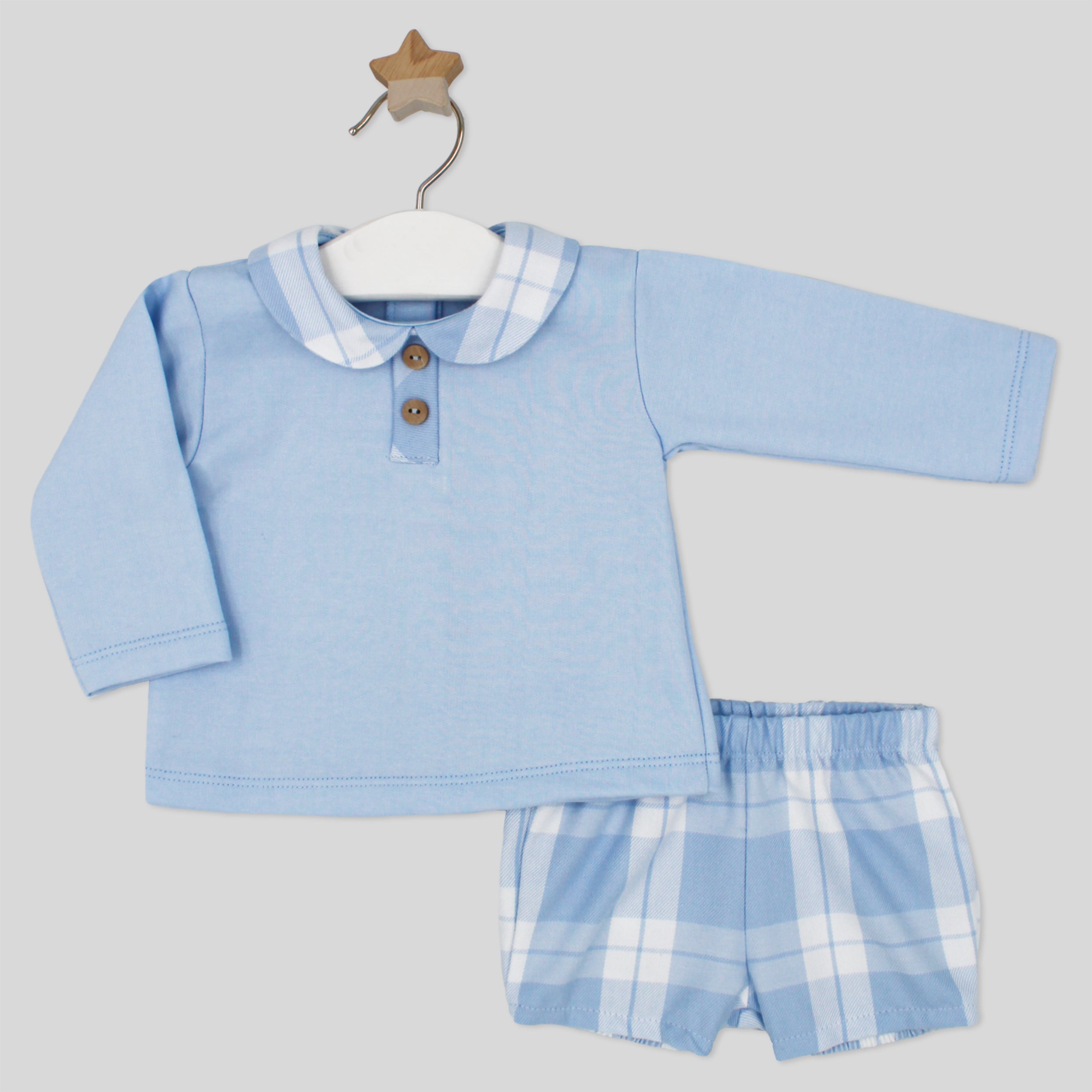 Baby outfit with blue long-sleeve shirt and checkered shorts on a hanger against a light gray background