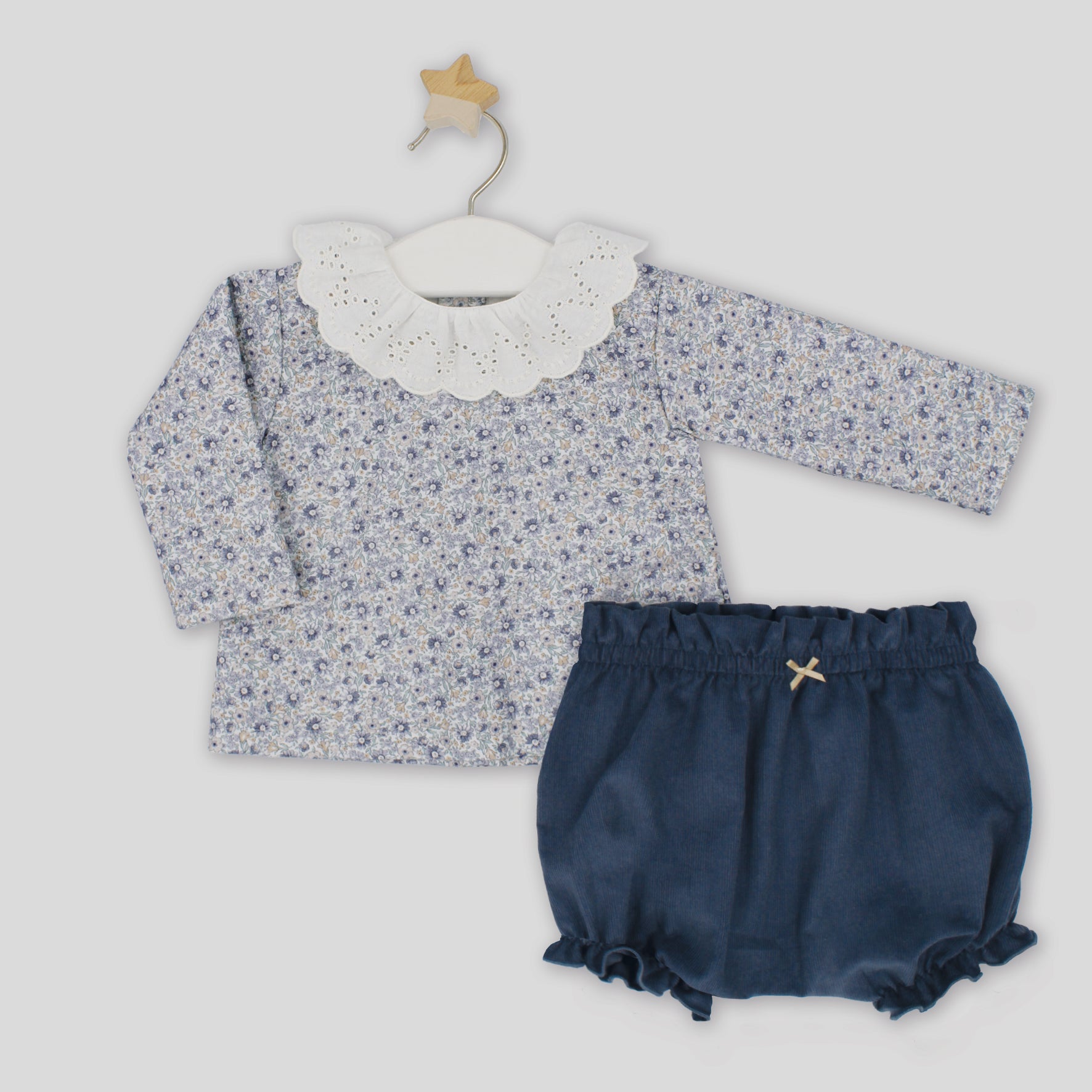 Floral top and navy bloomers on a white background