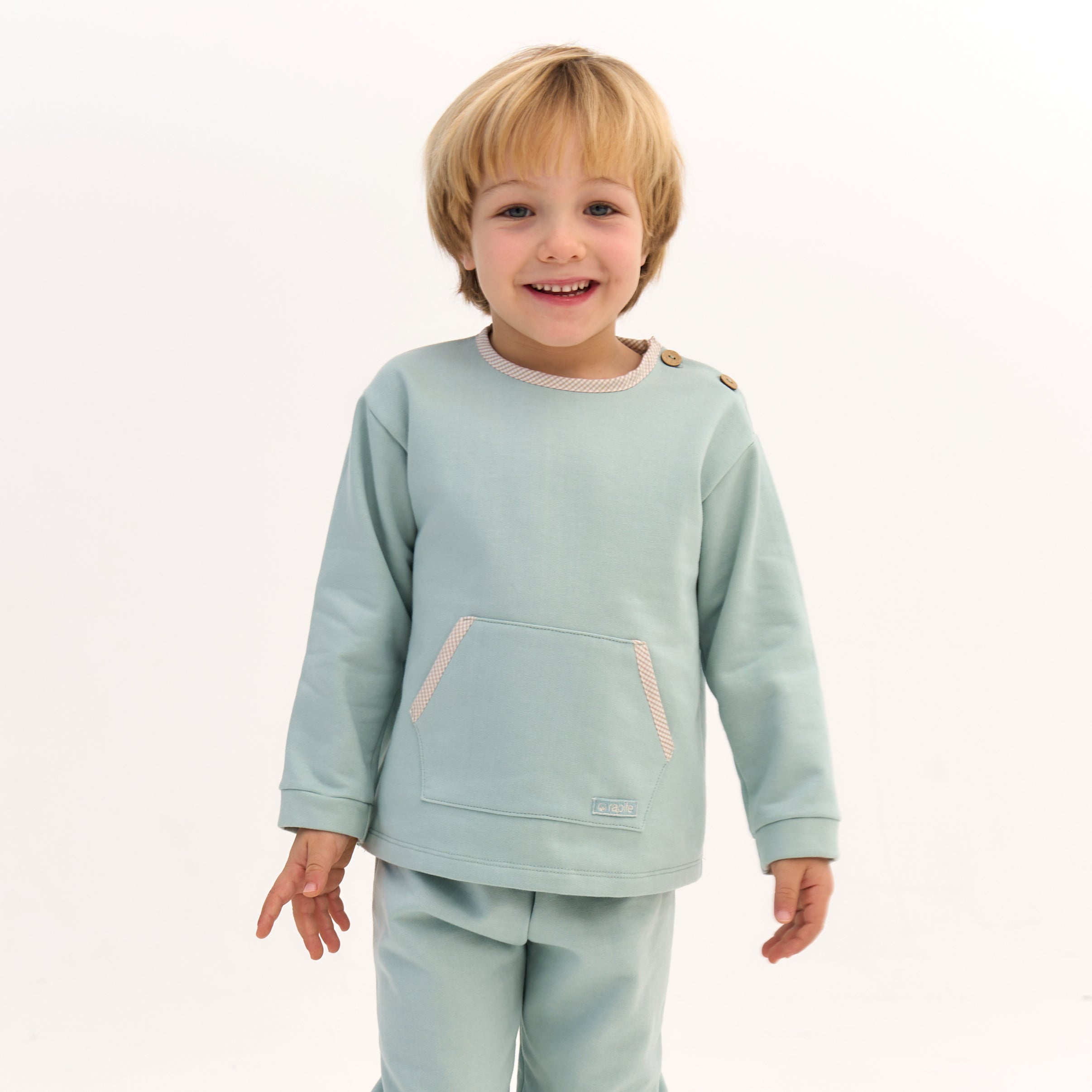 Child wearing a light blue outfit on a white background