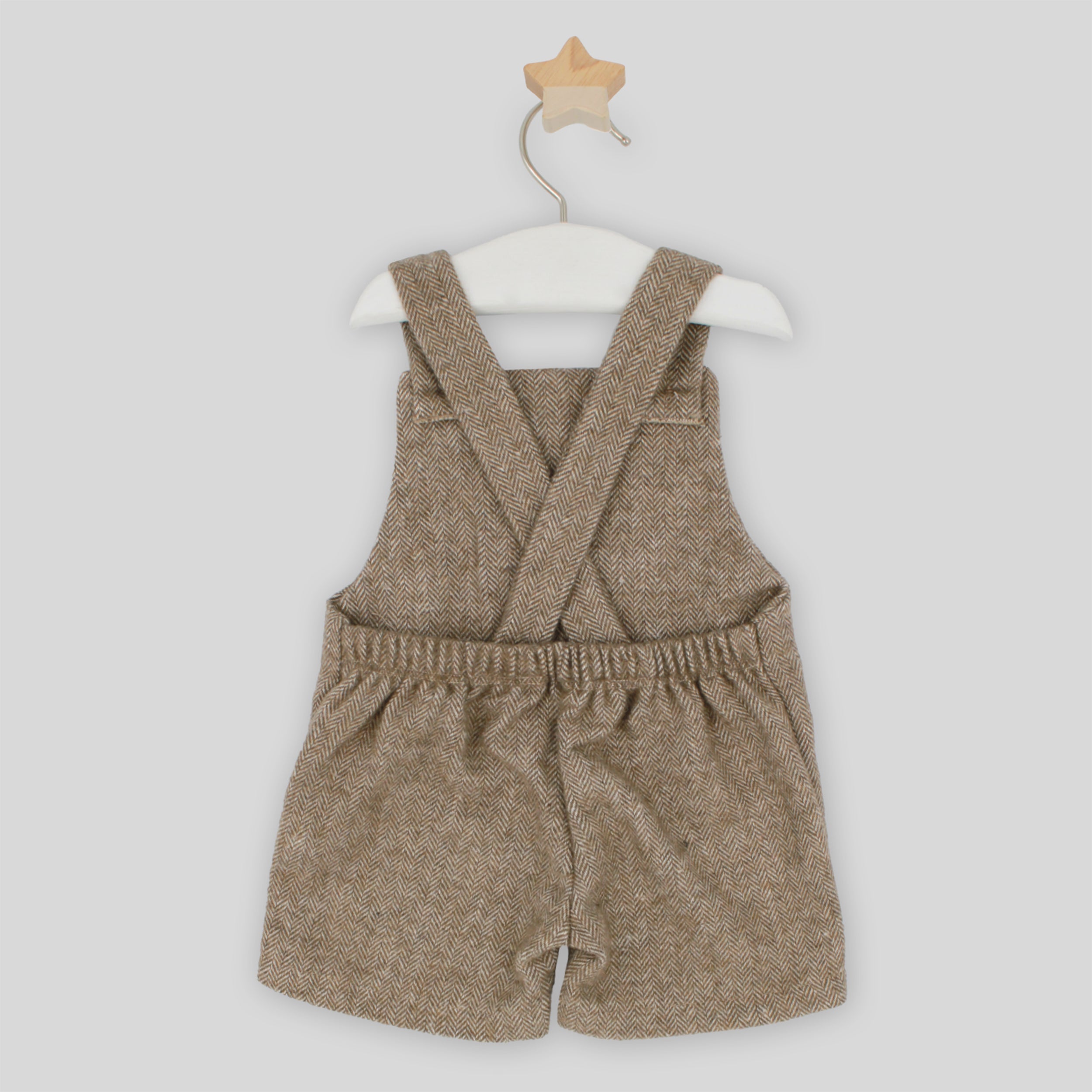 Brown herringbone patterned romper with suspenders on a white background