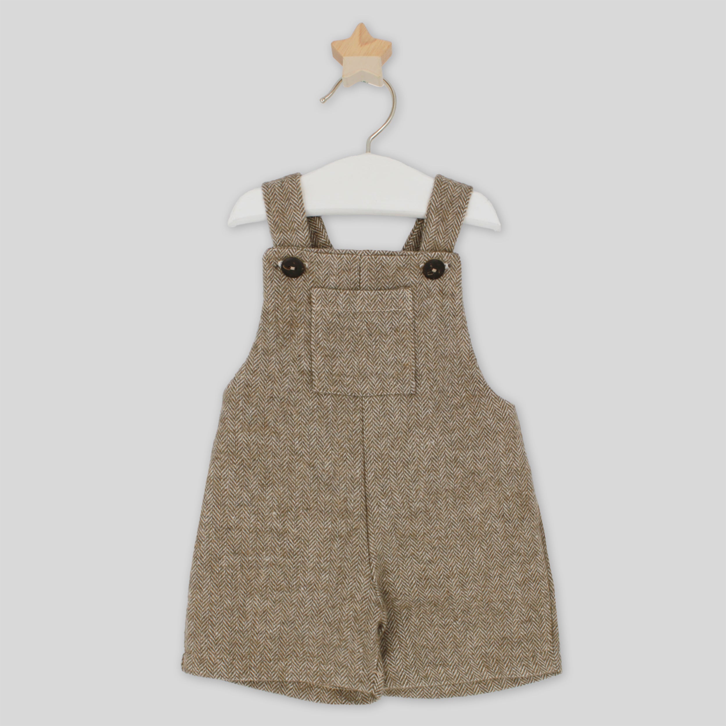 Brown herringbone patterned overalls on a white background