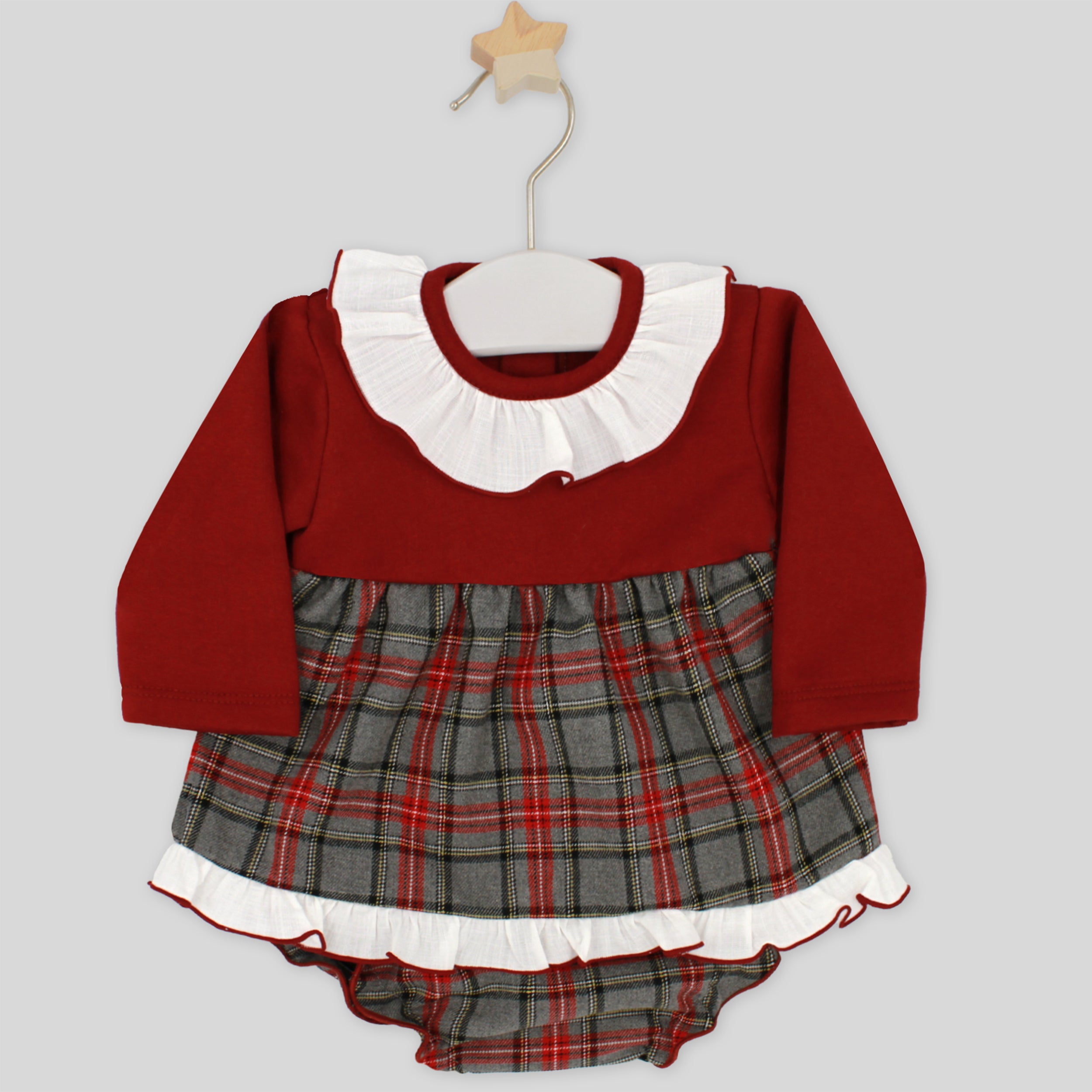 Red and plaid baby dress with white collar on a hanger against a light gray background