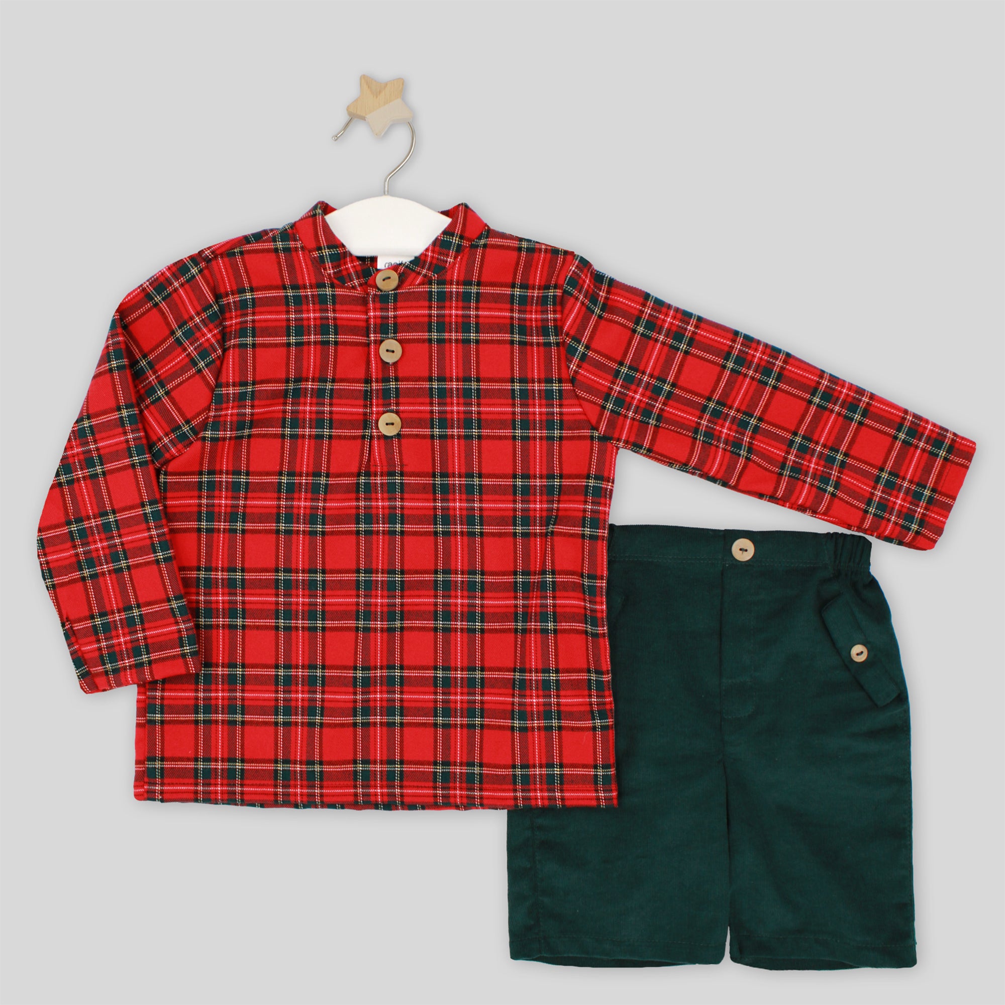 Red plaid shirt and green shorts set on a gray background