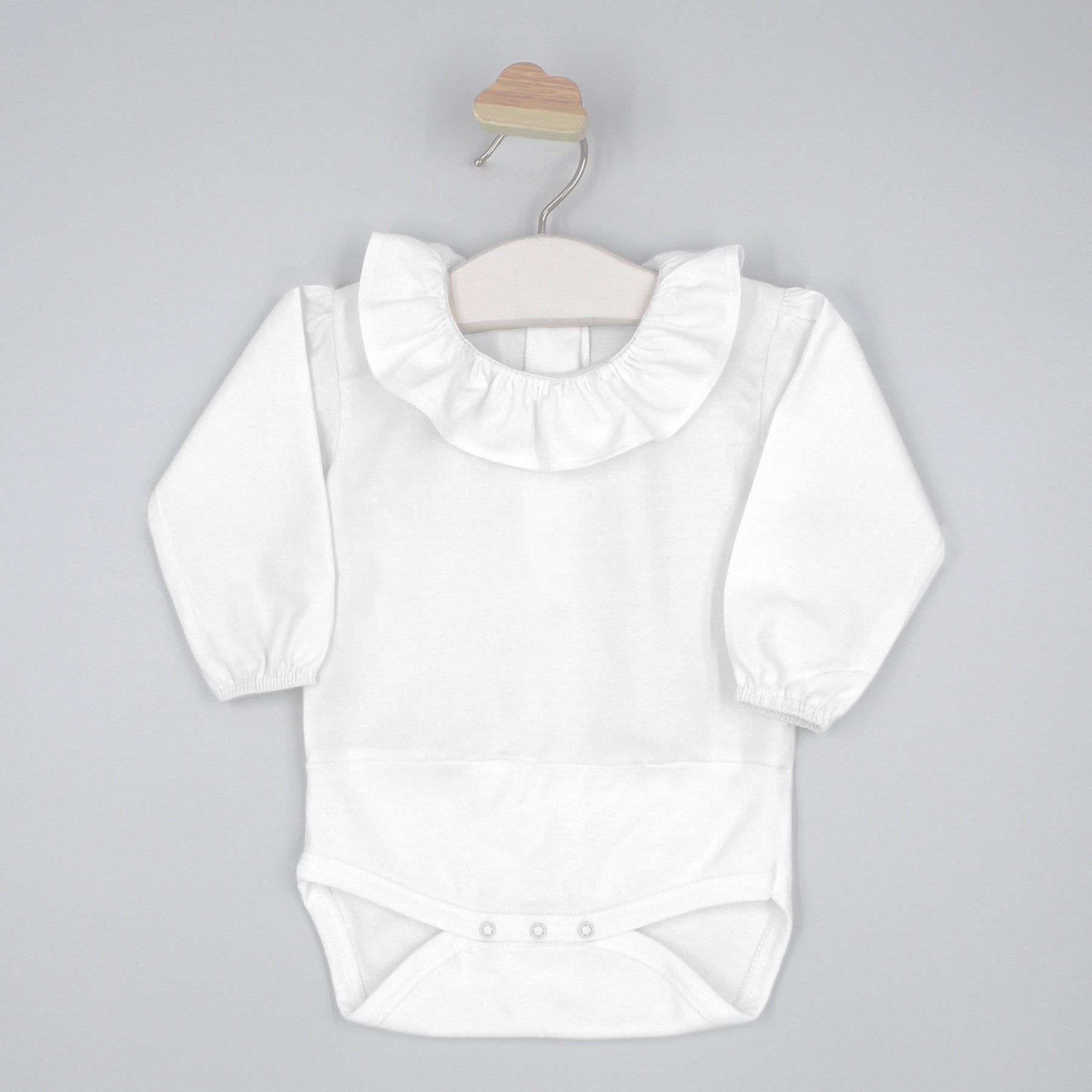 White baby bodysuit with ruffled collar on a gray background