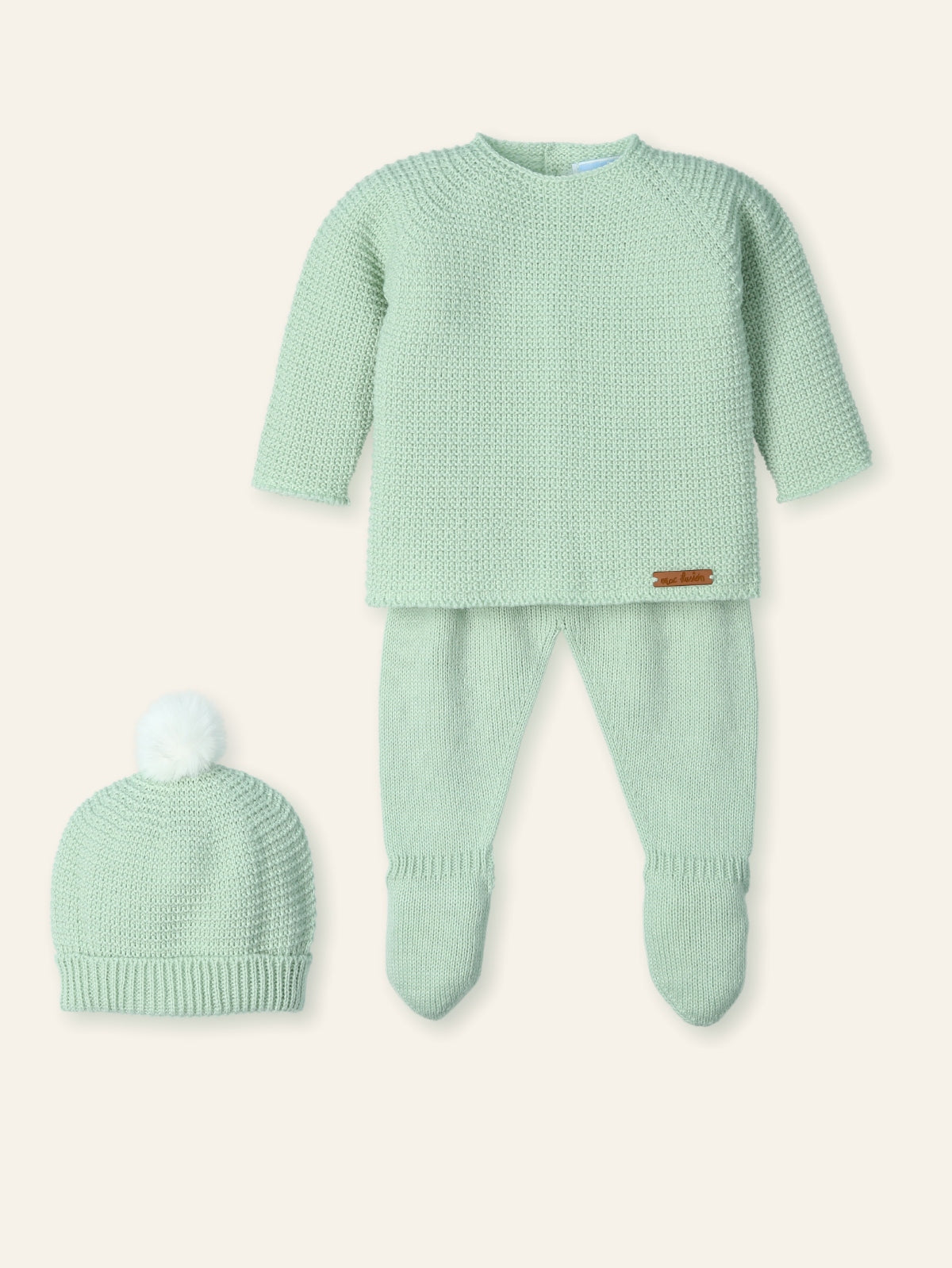 Green baby outfit with matching hat on a white background