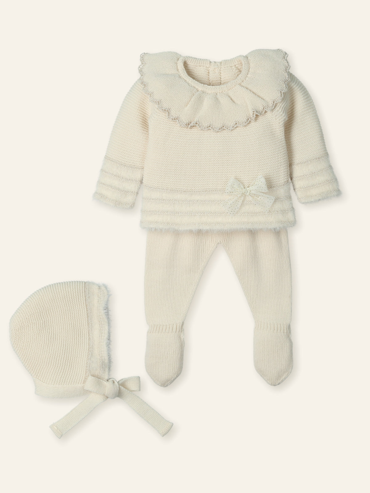 Baby outfit with sweater, pants, and bonnet on a white background