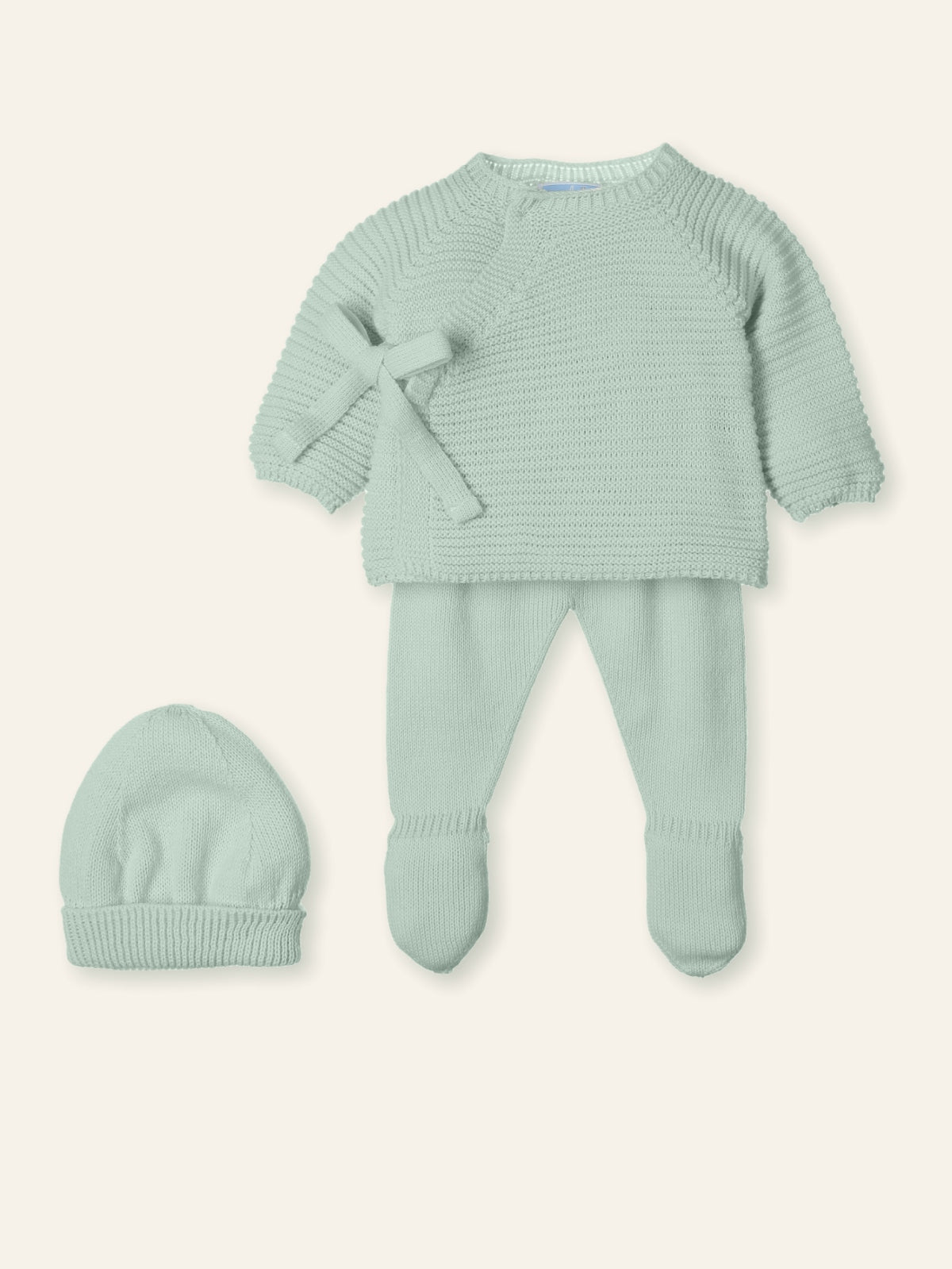Light green baby outfit with sweater, pants, and hat on a white background
