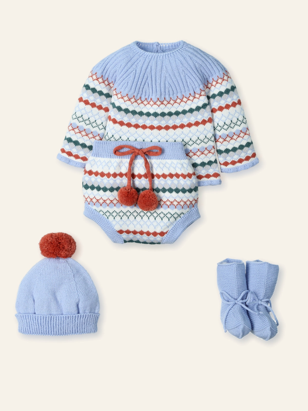 Baby outfit set with striped sweater, hat, and booties on a white background