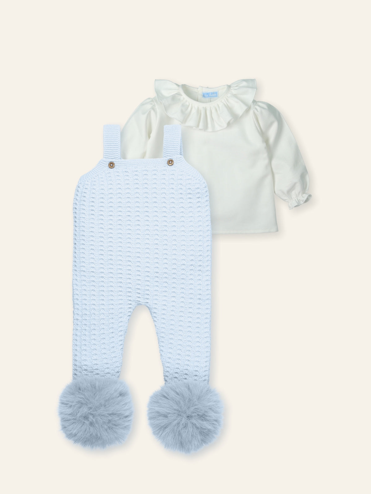 Light blue knitted romper with fluffy legs and white top on a light gray background