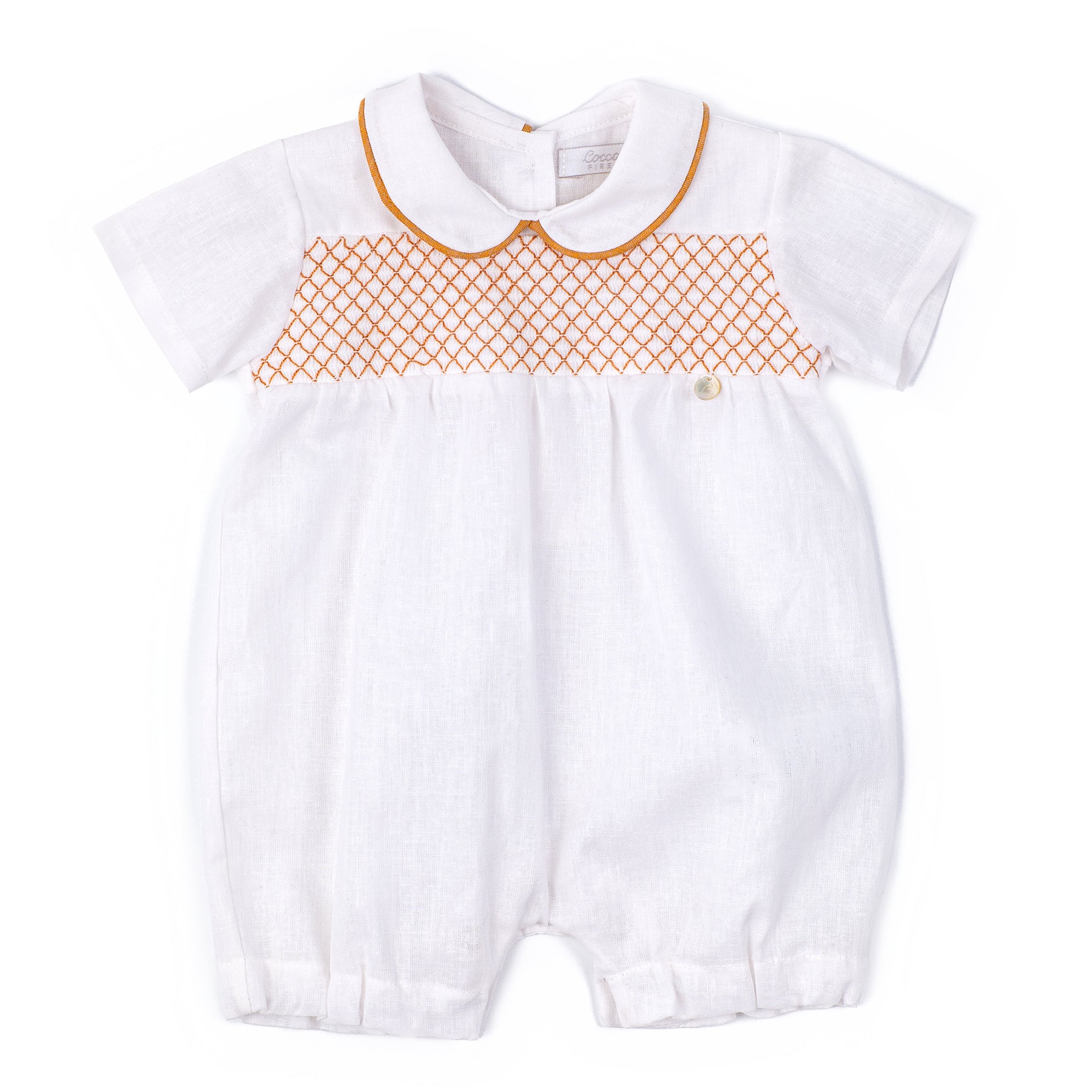 White baby romper with orange lattice pattern on a white background